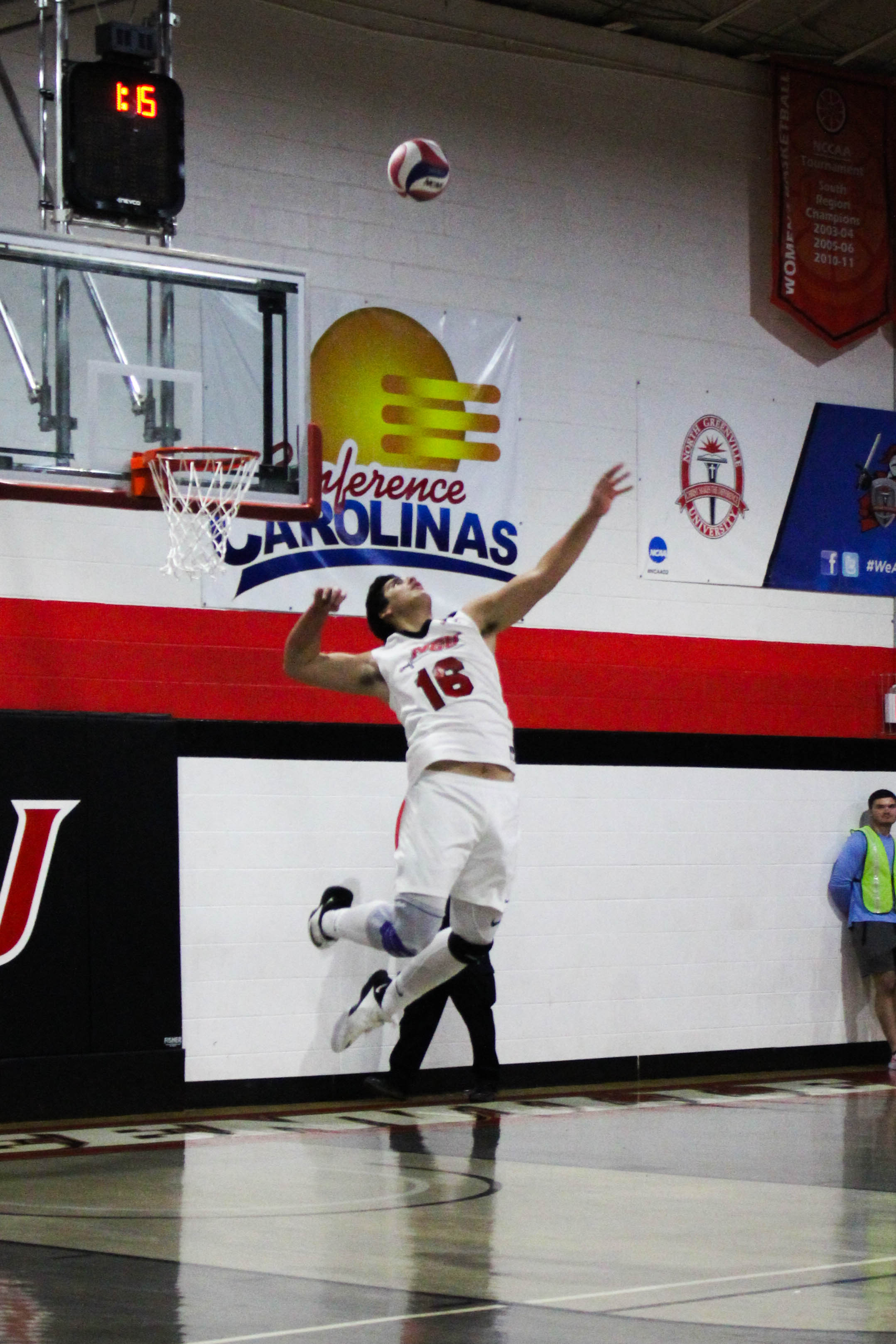 Freshman Sergio Carrillo (16) jumps to serve the ball.