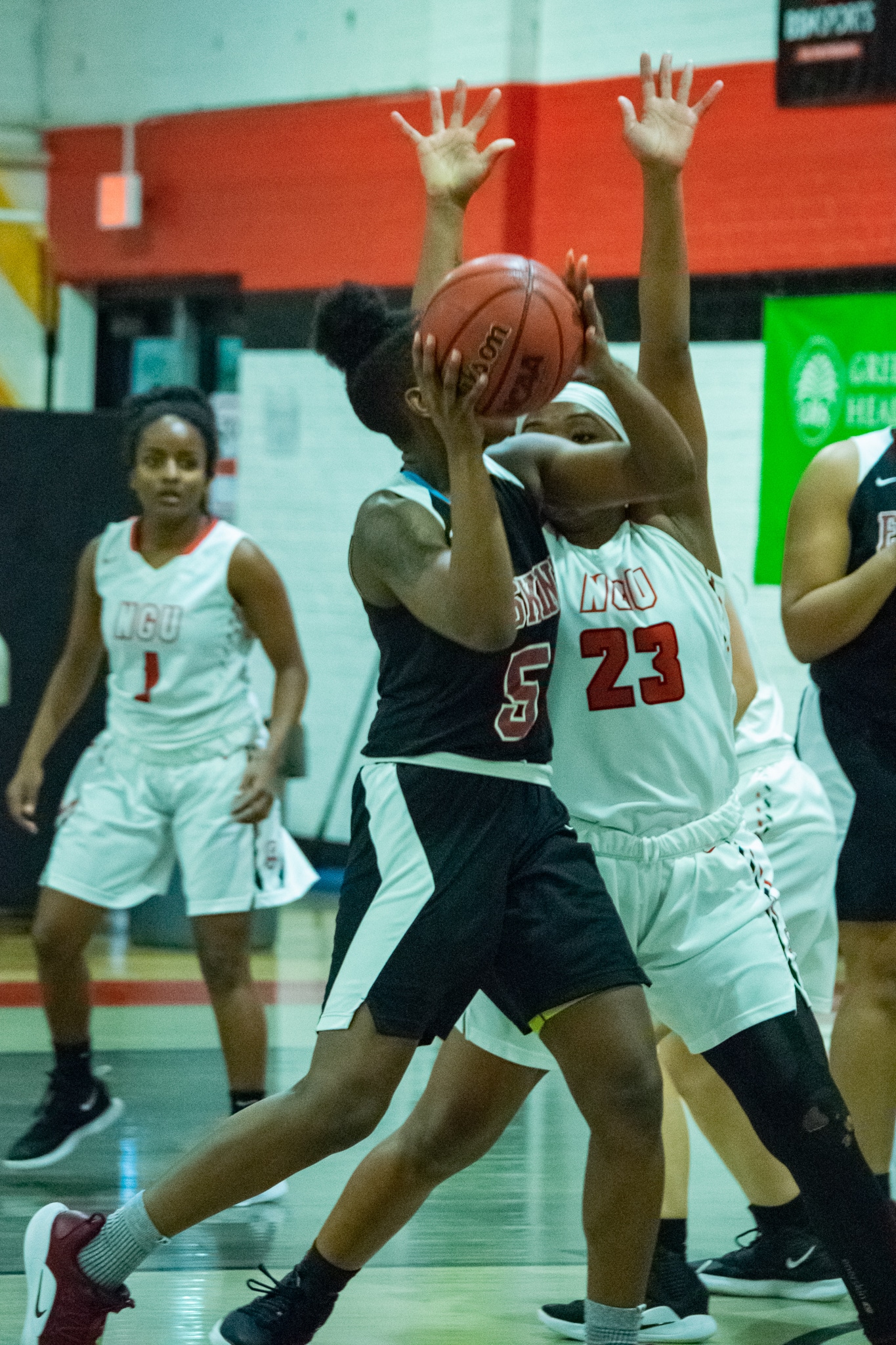 Sophomore Tyana Saunders (23) attempts to block her opponent from passing the ball to a teammate.
