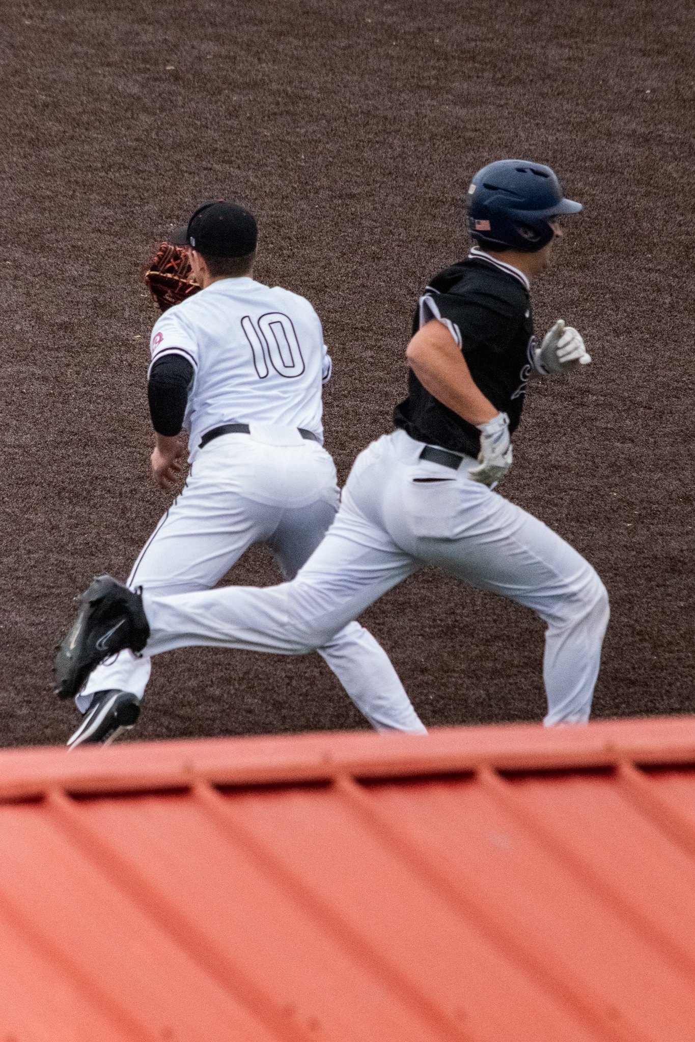 Sasser (10) stands on first base as he catches the ball to get his opponent out.