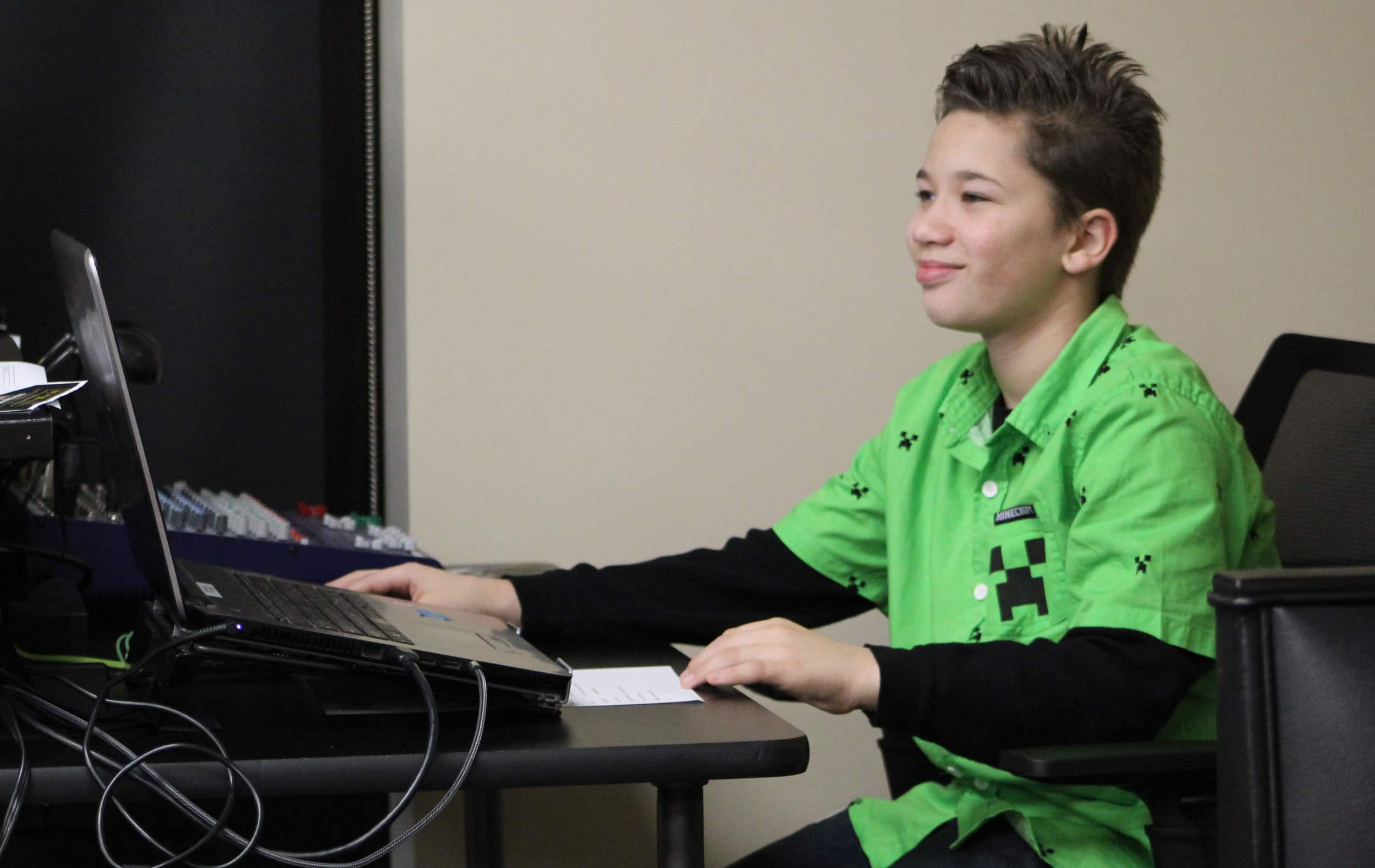 Fifth grader, Brian Fowler serves as the technician and computer operator for Trinity Kids.