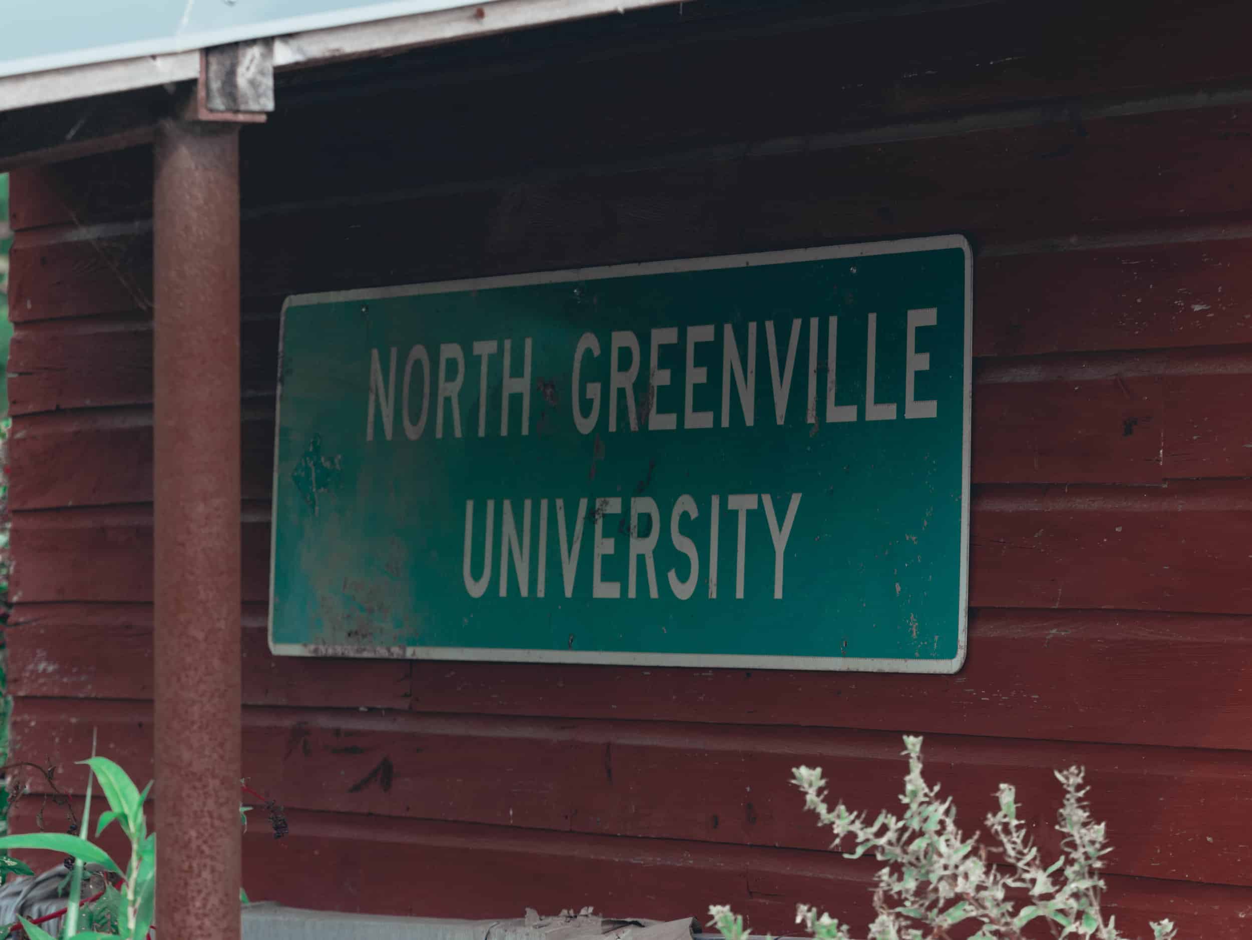 Old road sign on a maintenance building