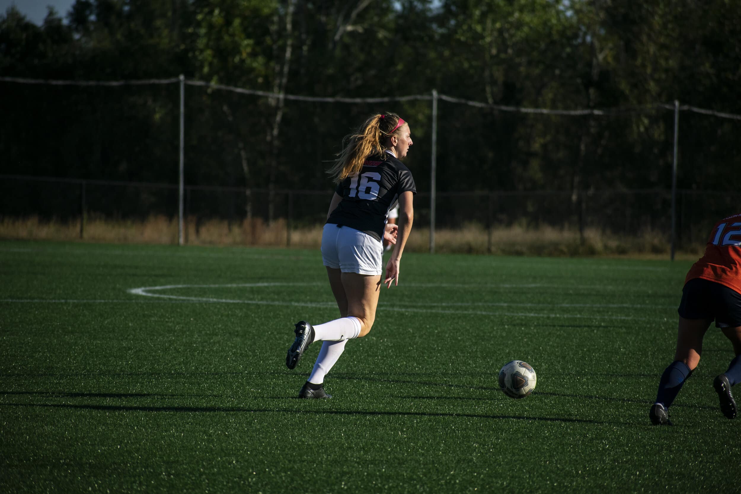 Sophomore Shelby Shepherd (16) aims to reach the Eagles side of the field.