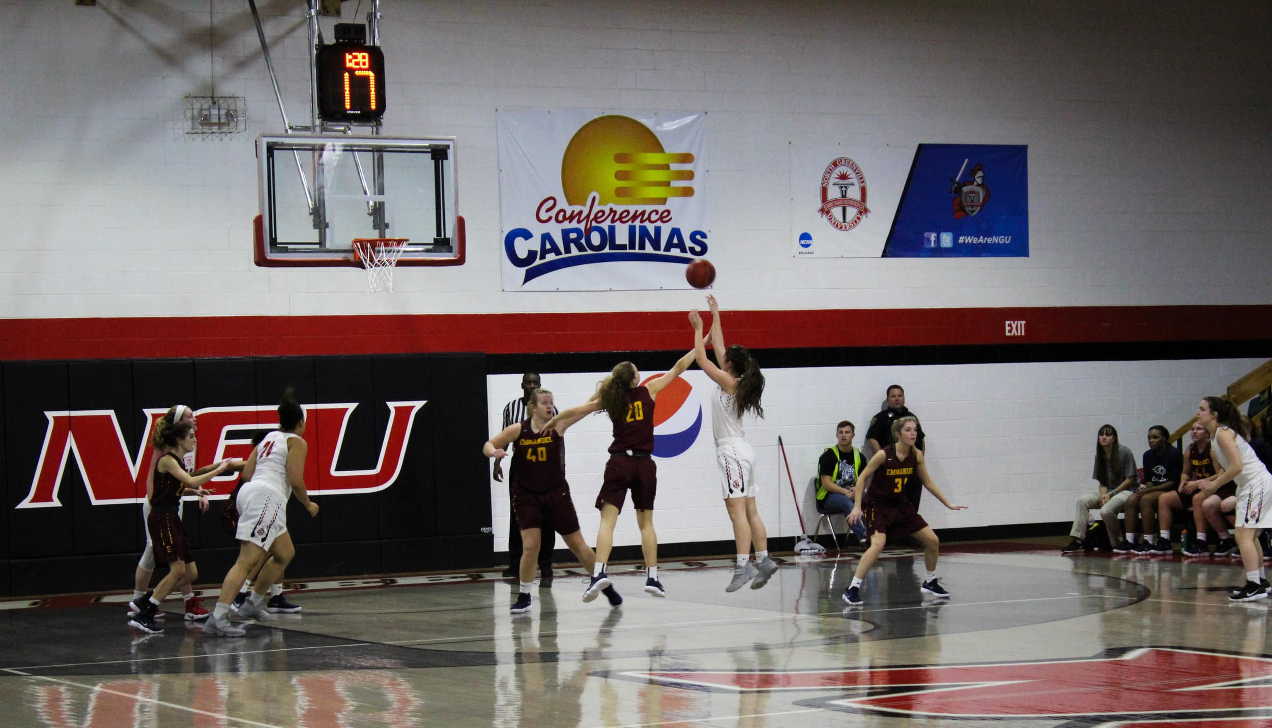 One of Emmanuels guards defends Ayano Shelton (12). She shoots the ball and makes a basket.