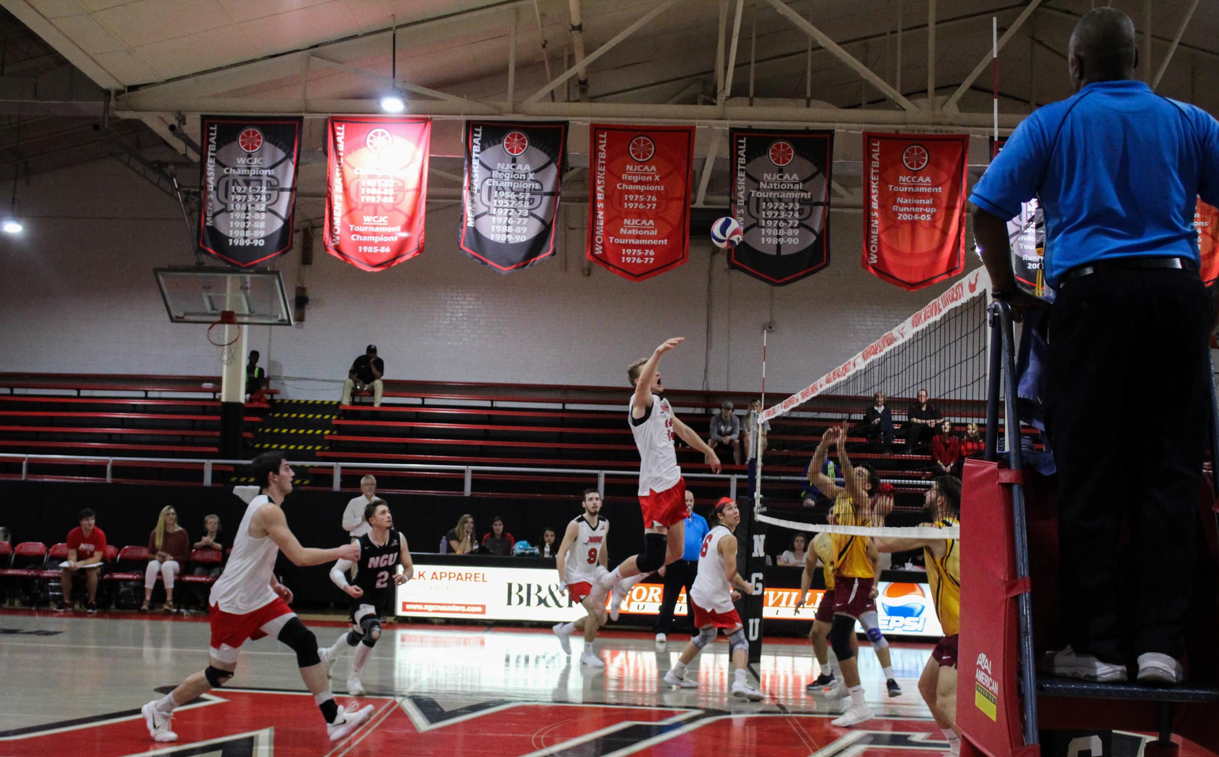 Ben Hamsho (13) jumps to spike the ball past Emmanuels players.