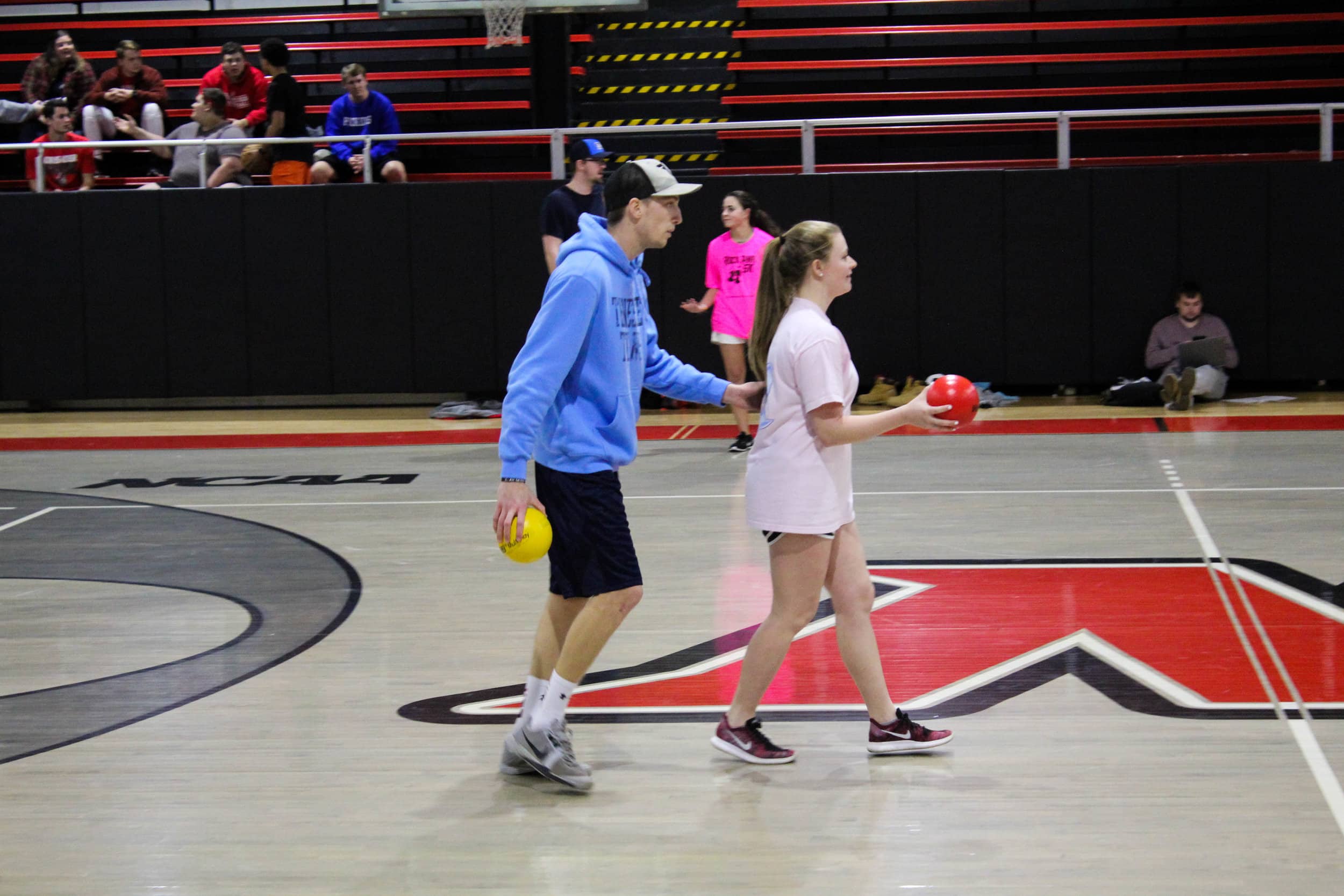 Junior Adam Daniel urges junior, team captain Abby Malcom forward to face the other team at the central line in the court.