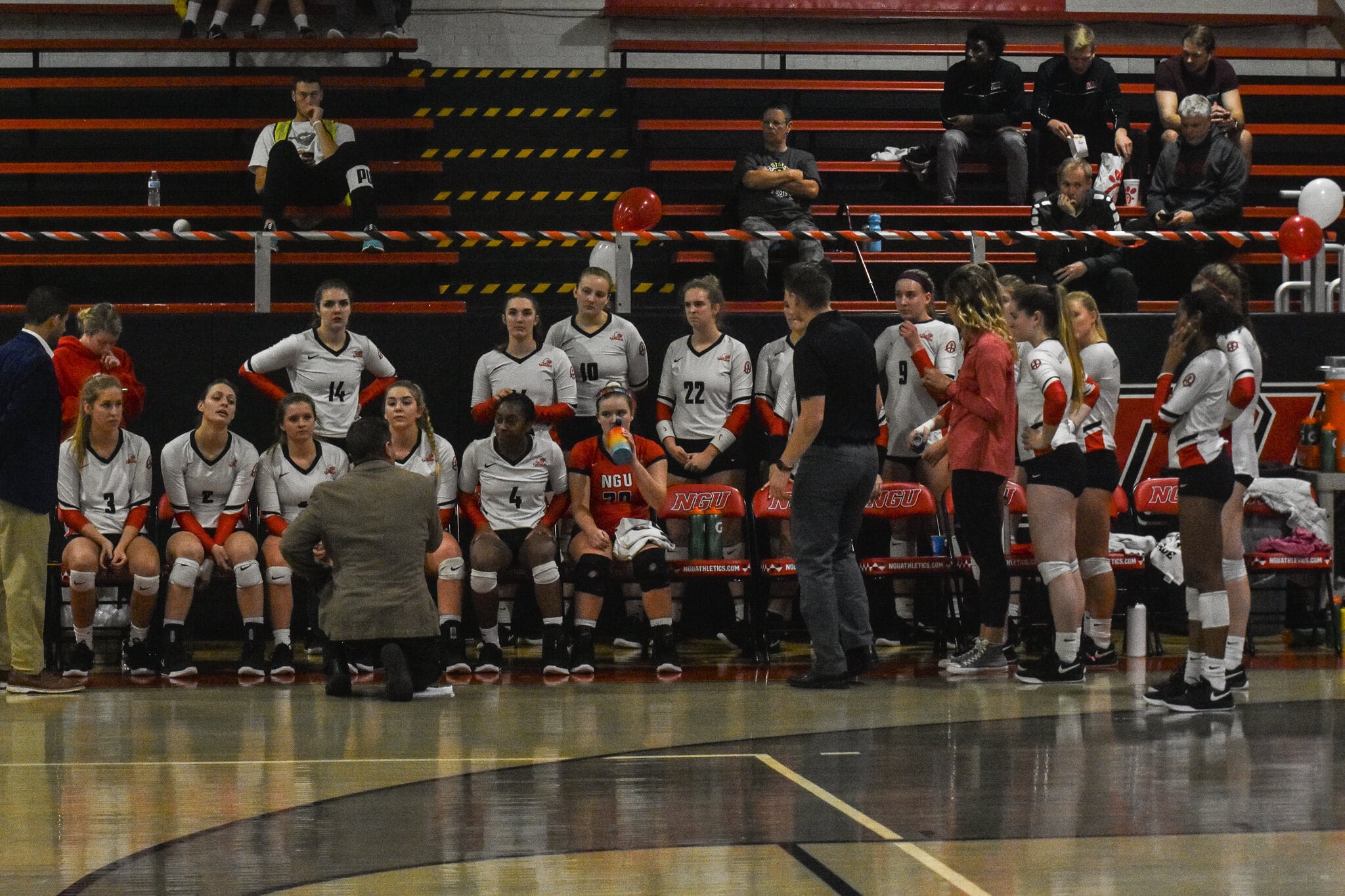 The coaches talk to the team during a time out.