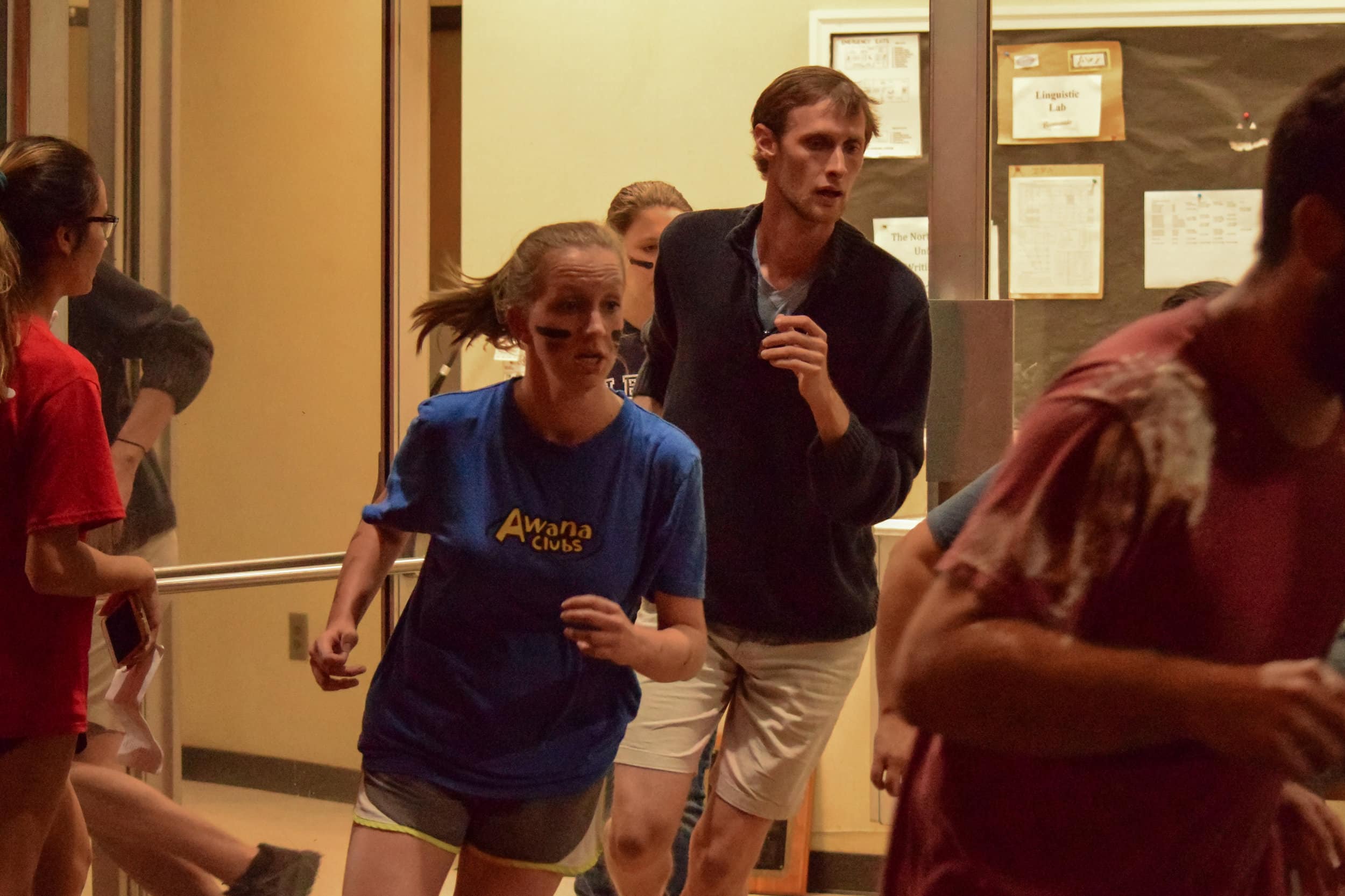 Education club members Cody Pendarvis, senior, and Constance Revis, junior, rush after their team as they finish the trivia section of the race.