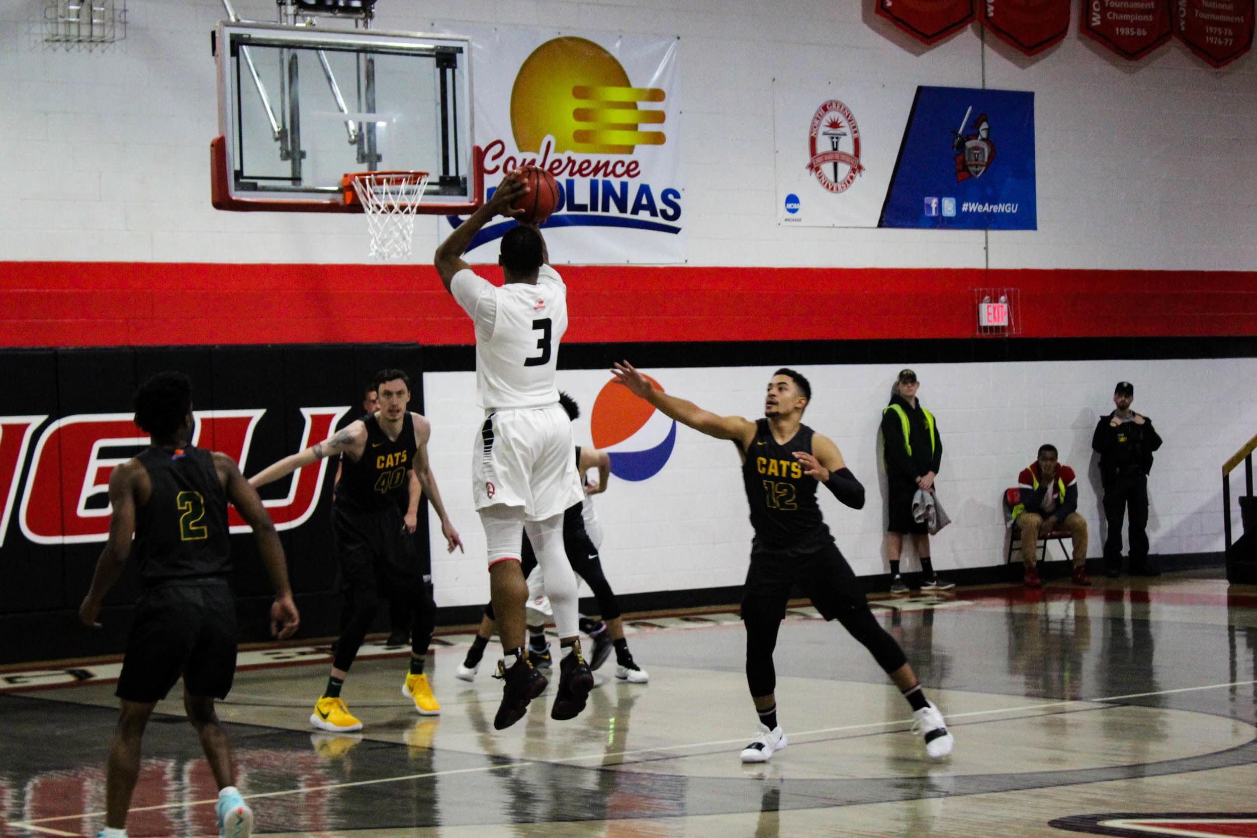 Sophomore Kovi Tate (3) jumps to shoot a three pointer.