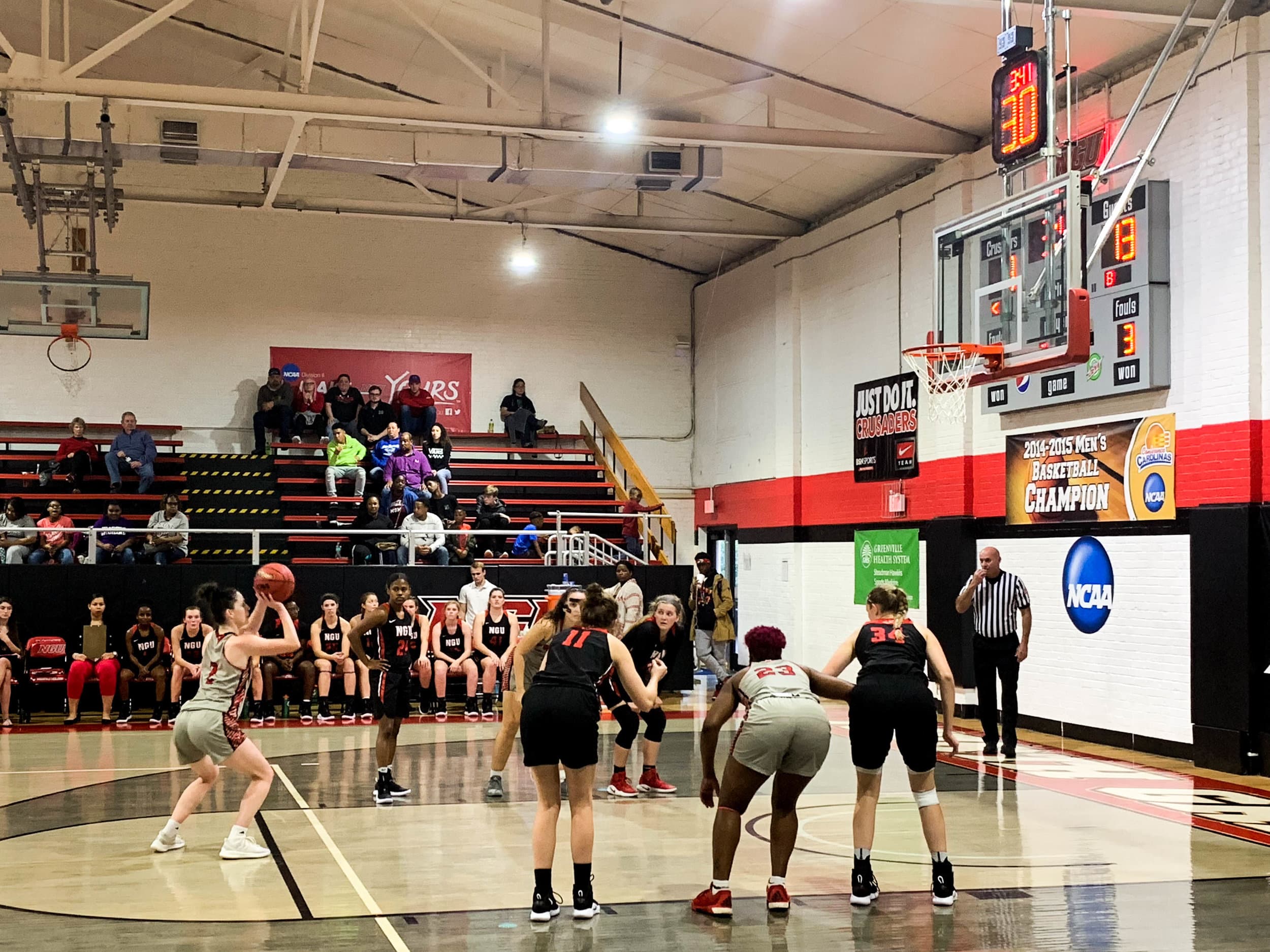 Senior Kyli Schmitt (11) and sophomore Bailey Breazeale (34) box out as a Newberry College player shoots a free throw.