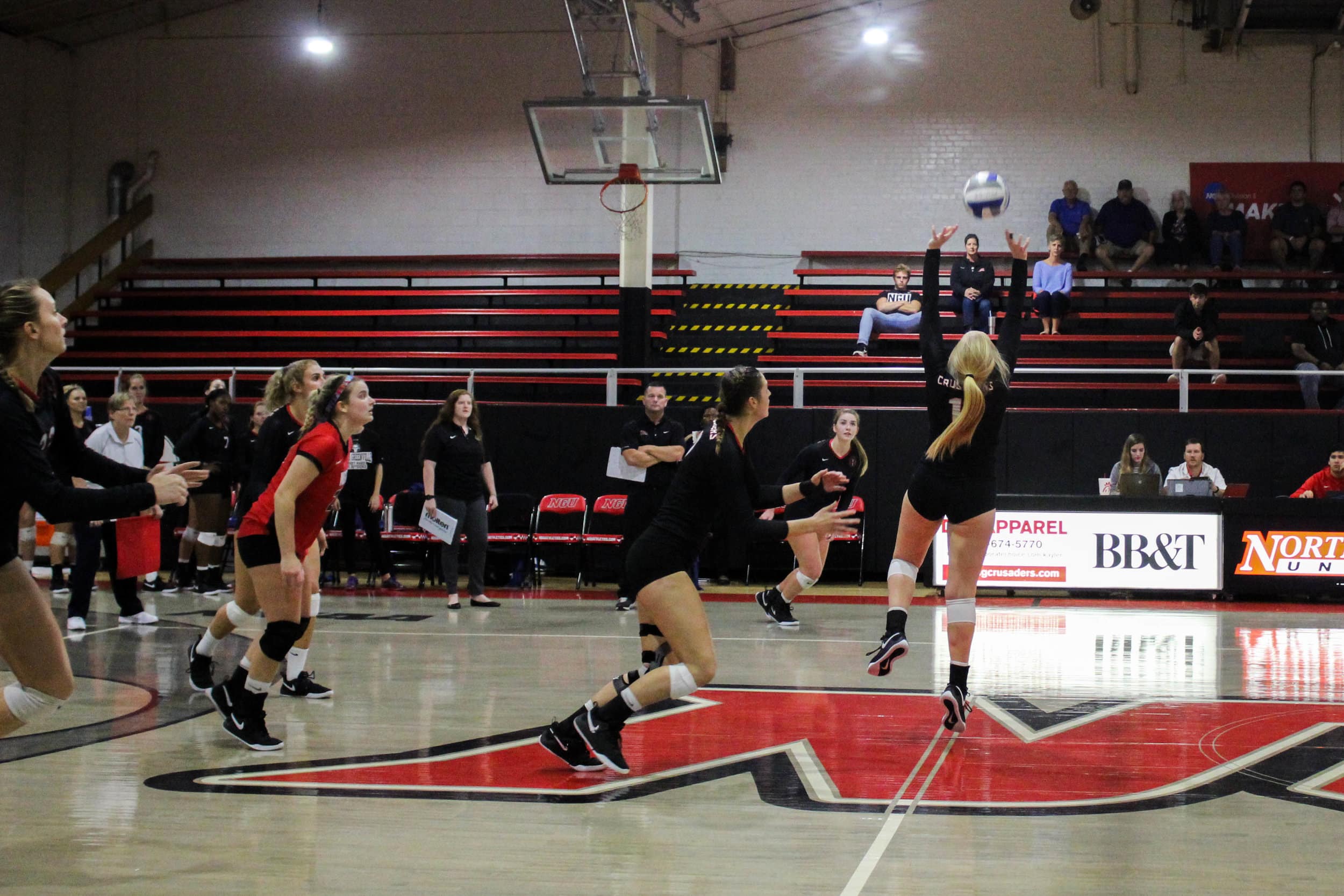 Senior Annie Beisecker (17) runs forward as she prepares to hit the ball set up by senior Sara Miller (11).