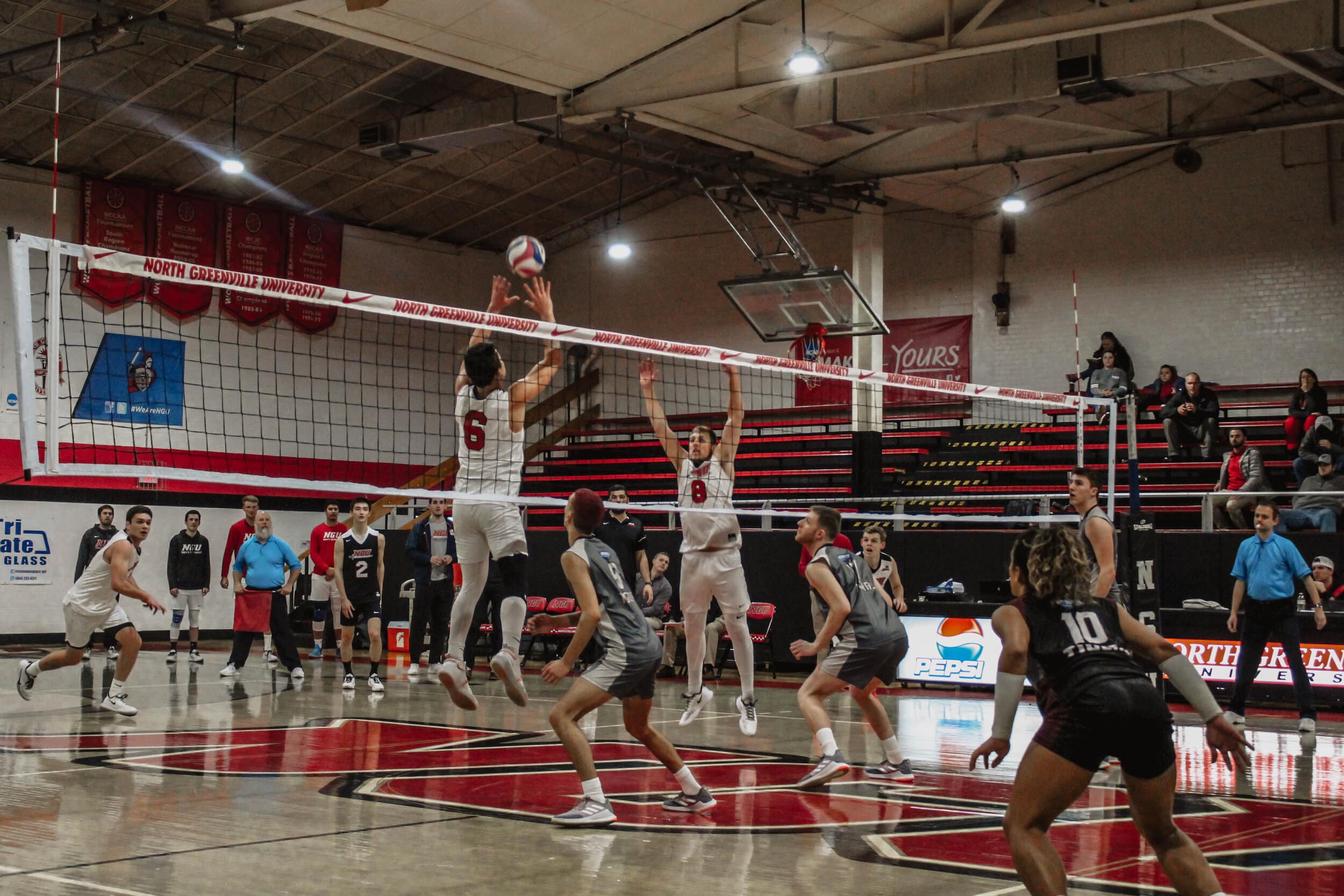 Sophomore Carter Eby (8) jumps as Jake Boldog sets the ball to him.