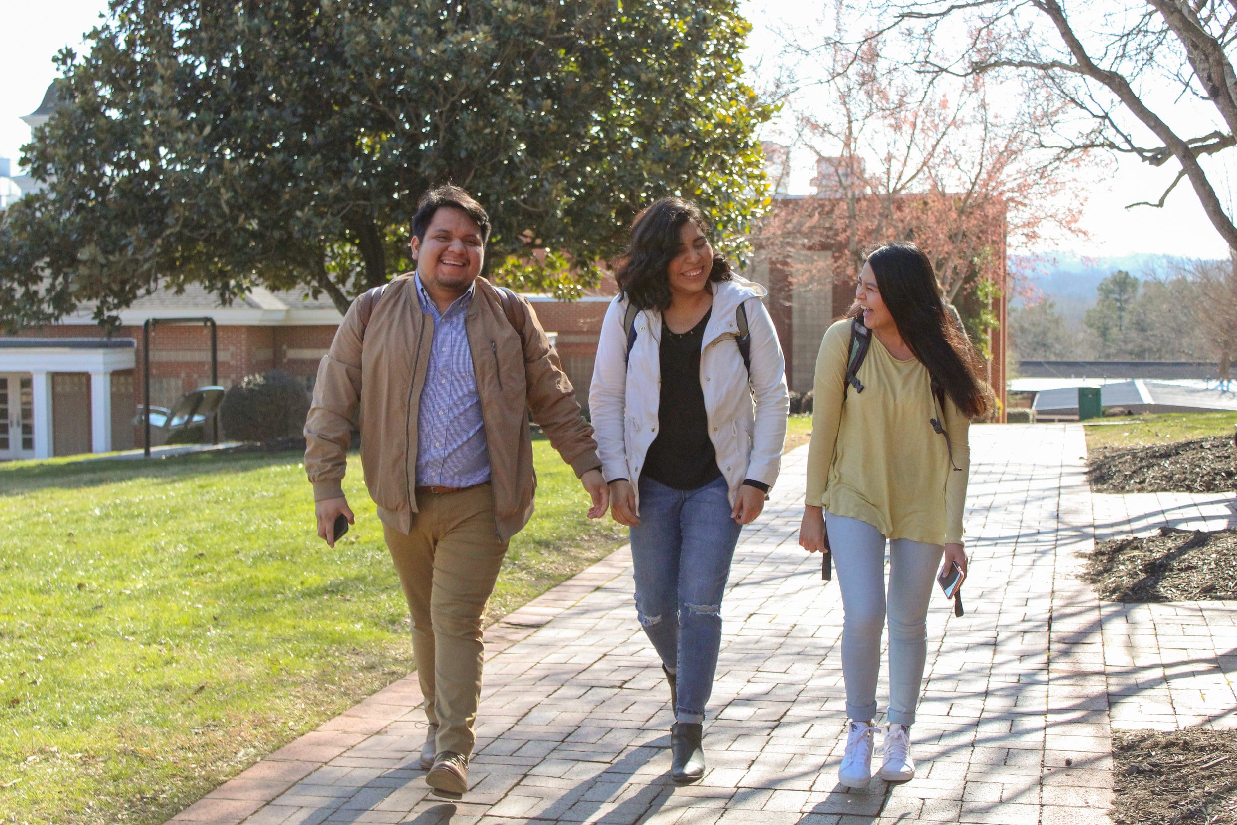 Senior Luis Travis, freshman Vanessa Martinez, and sophomore Mary Garcia catch up while walking to their next class.