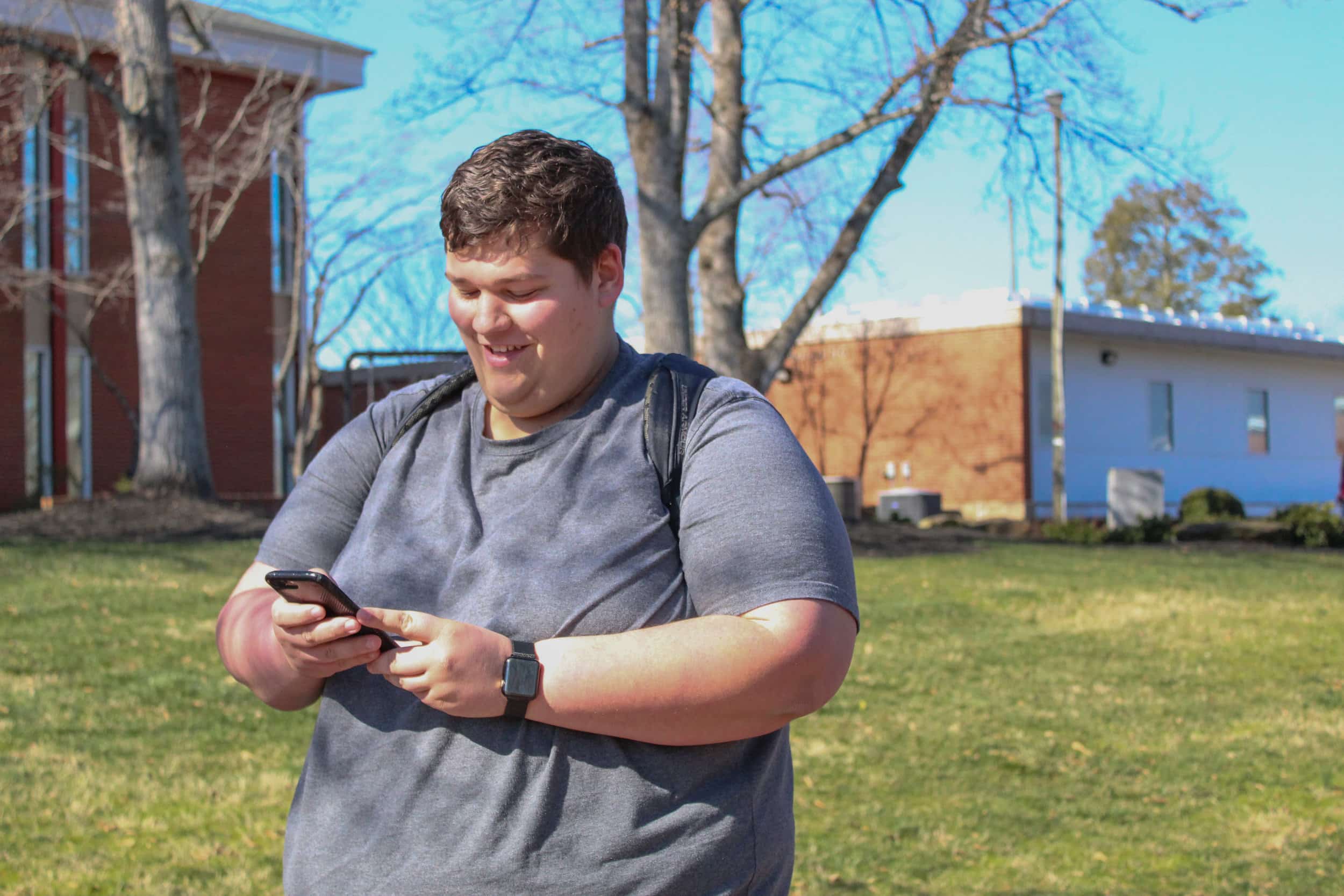 Sophomore Bo Felton checks his phone walking across campus.
