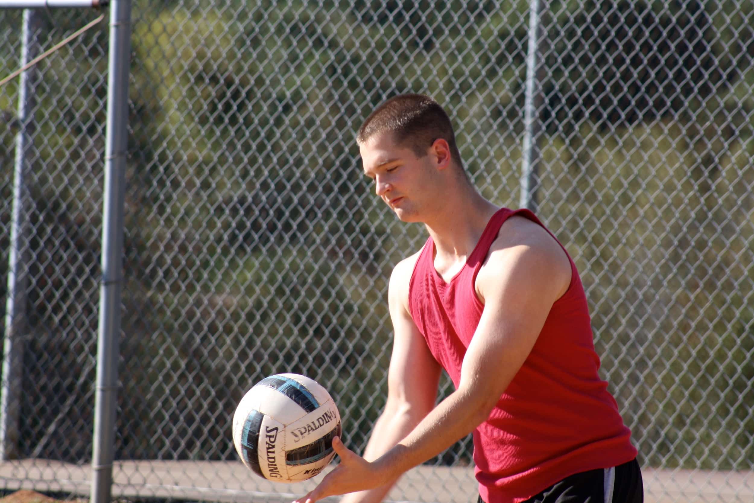  A student serves the ball for his team. 