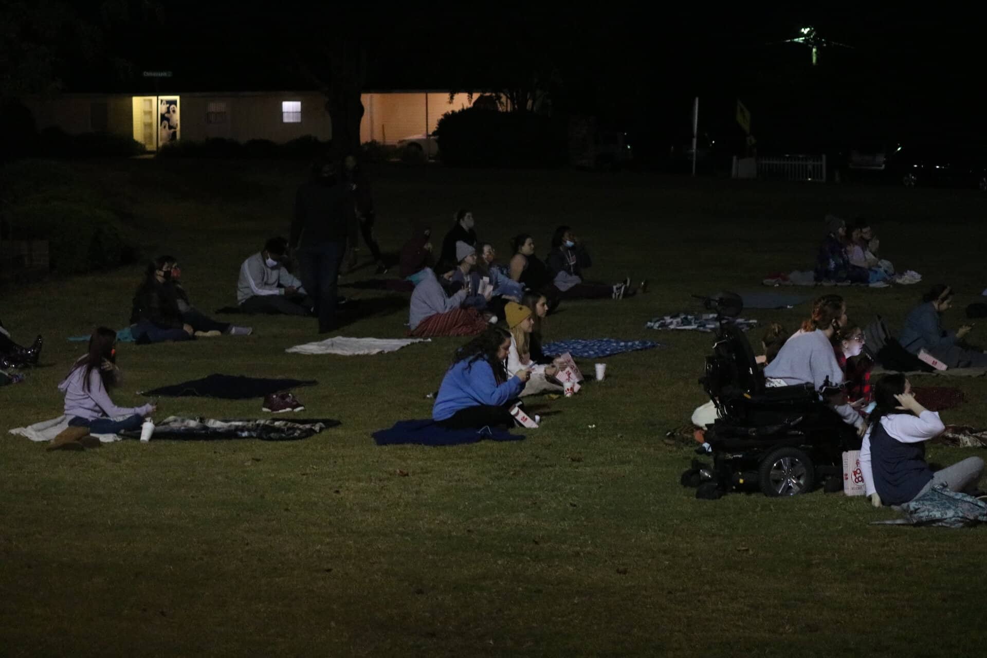 Students gather together to enjoy Hocus Pocus under the stars.