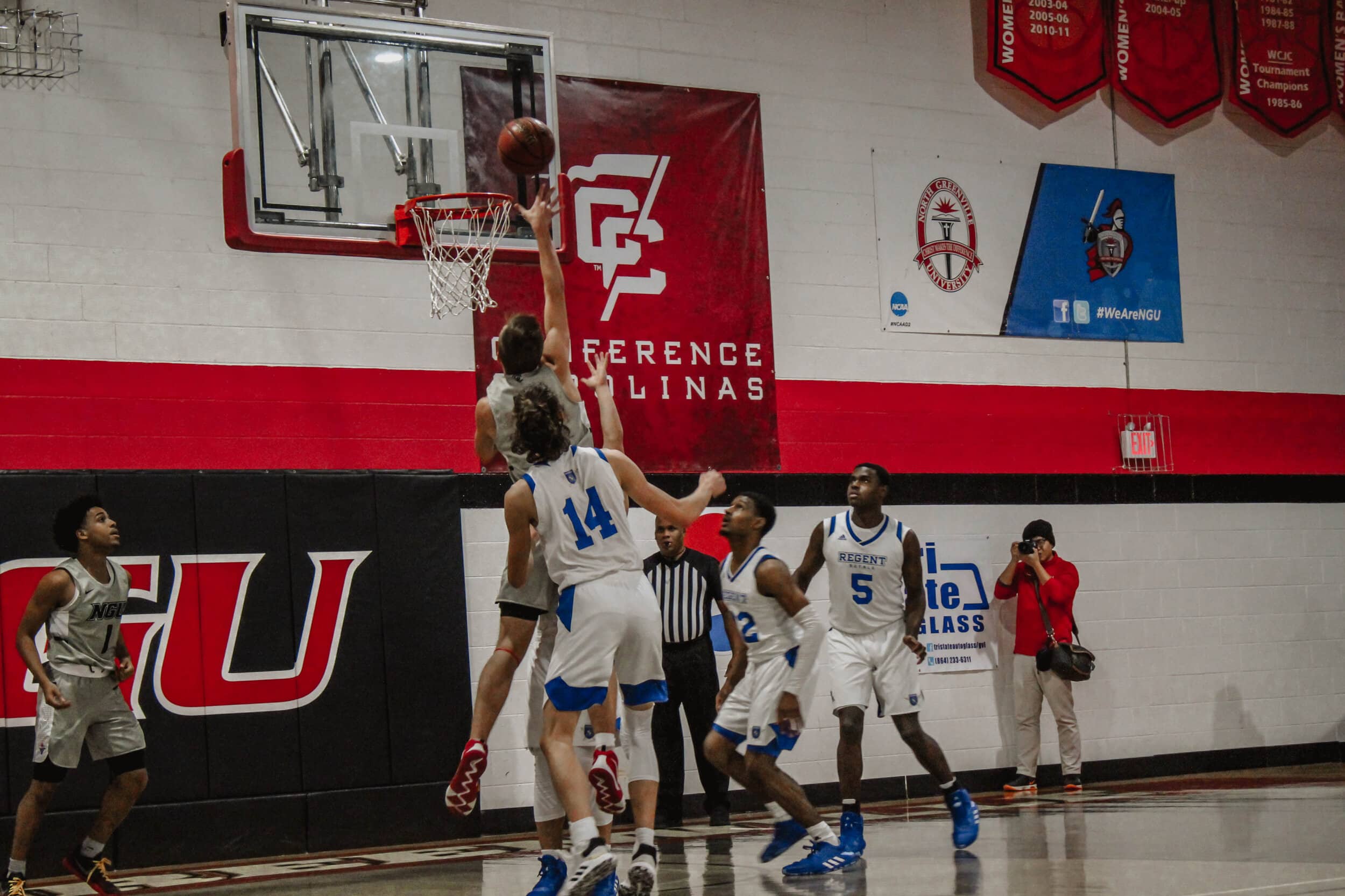 After driving down the lane to the basket, freshman forward Seth Hewitt (15), makes a basket.