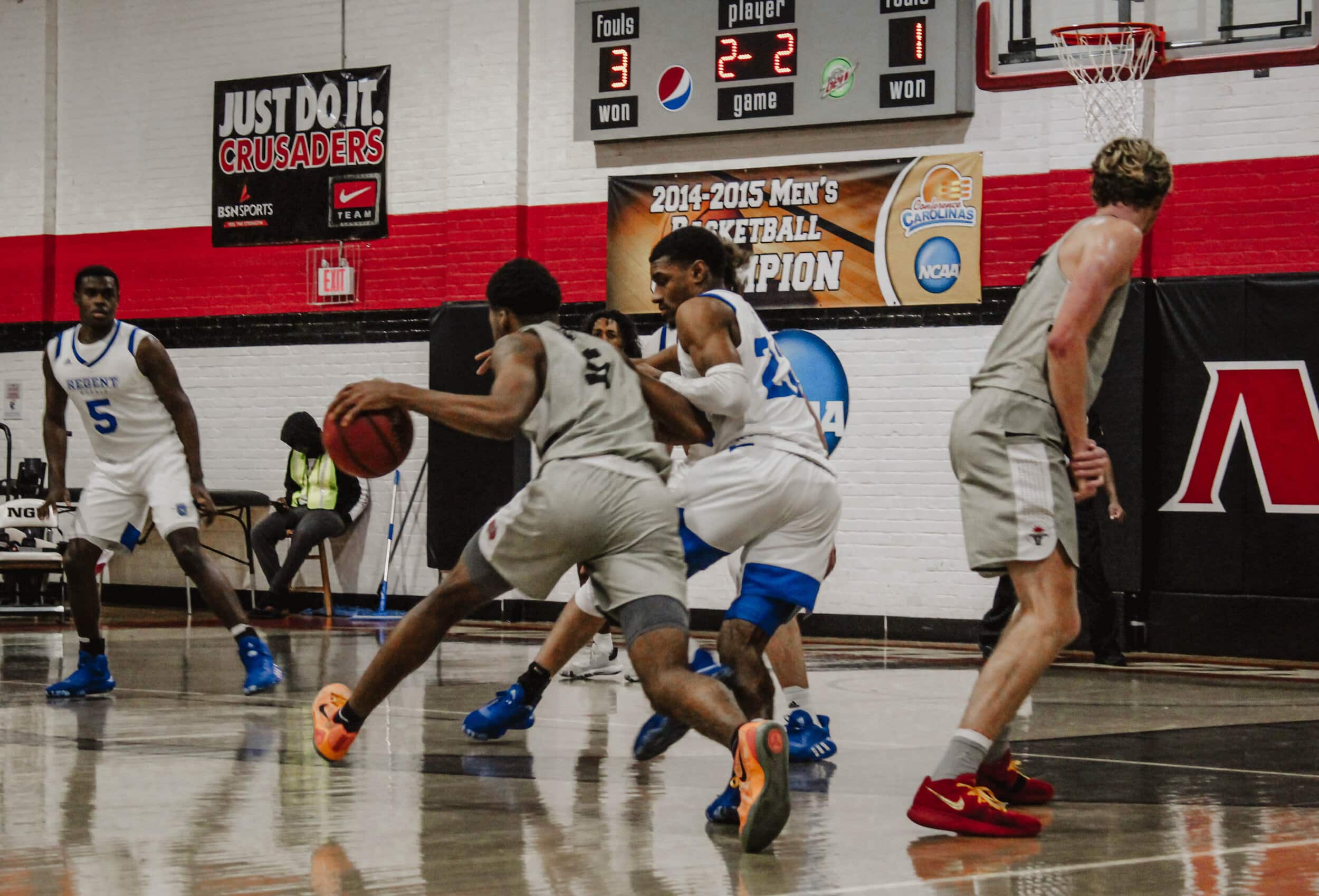 After a defender breaks the pick set by Joe Conley (24), junior Jalon Cokley (5) drives past the defender toward the basket.