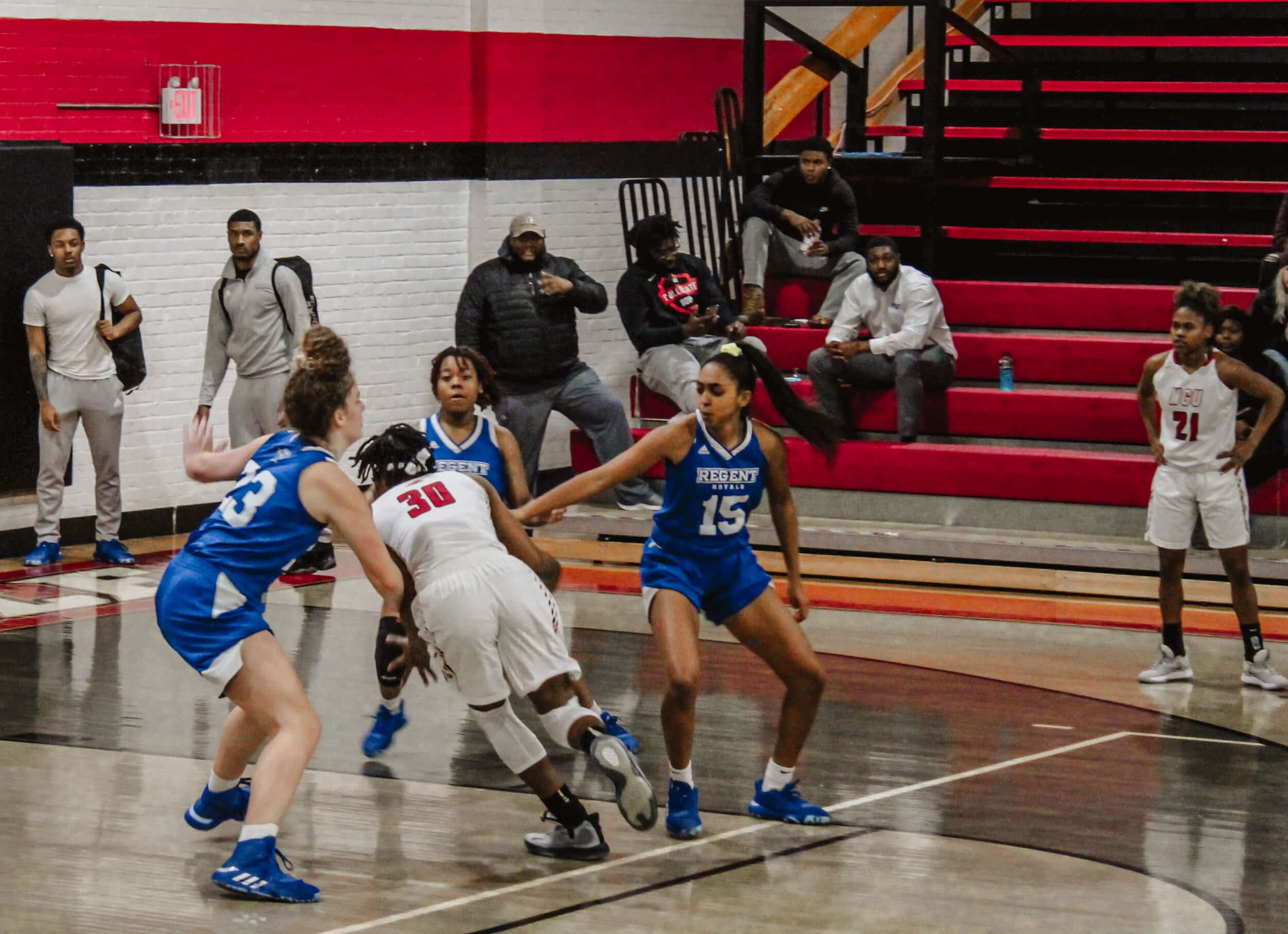 Junior Peace Okeke (30) drives through the lane toward the basket.