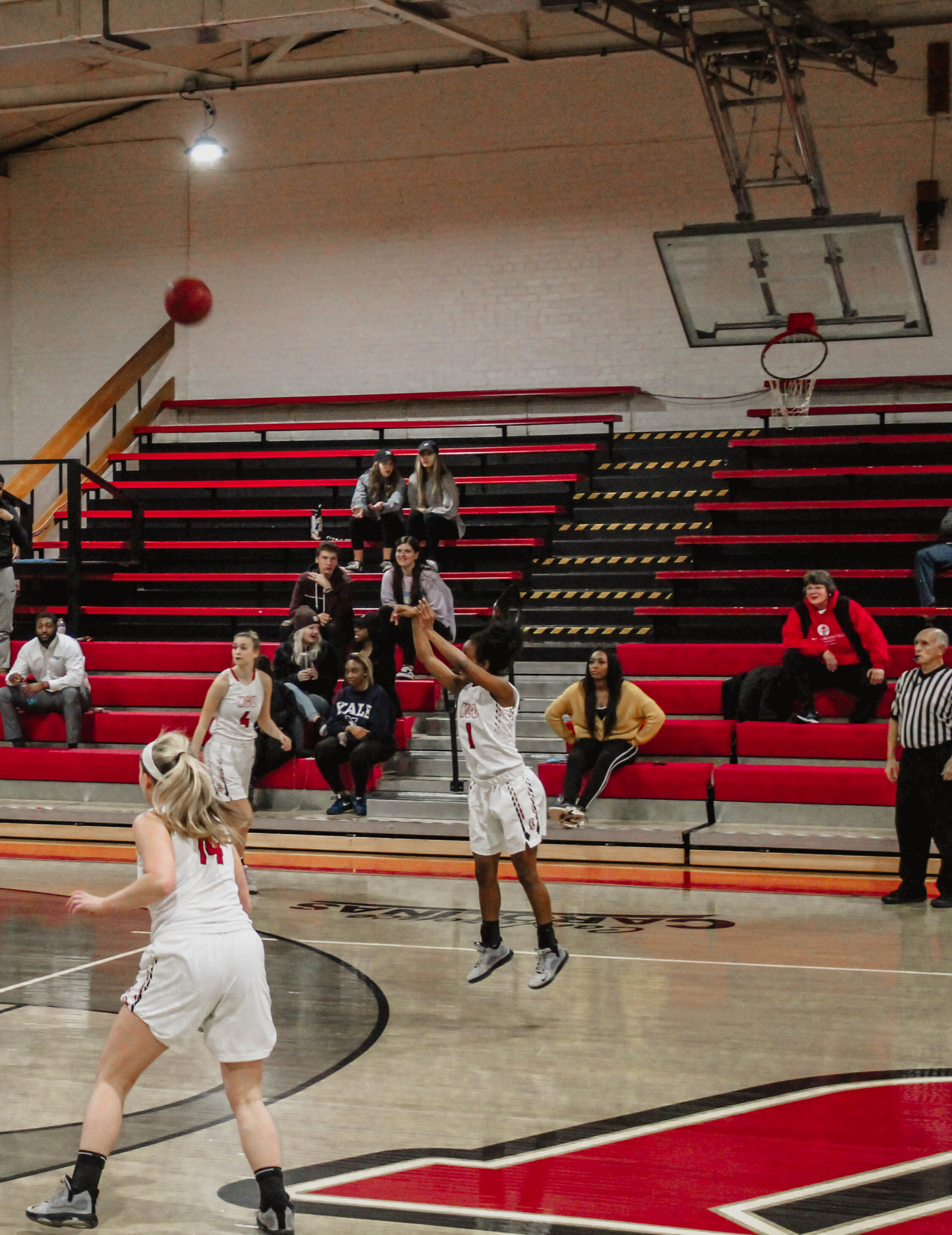 Journey Muhammed (1), sophomore point guard, takes a three  point jump shot.