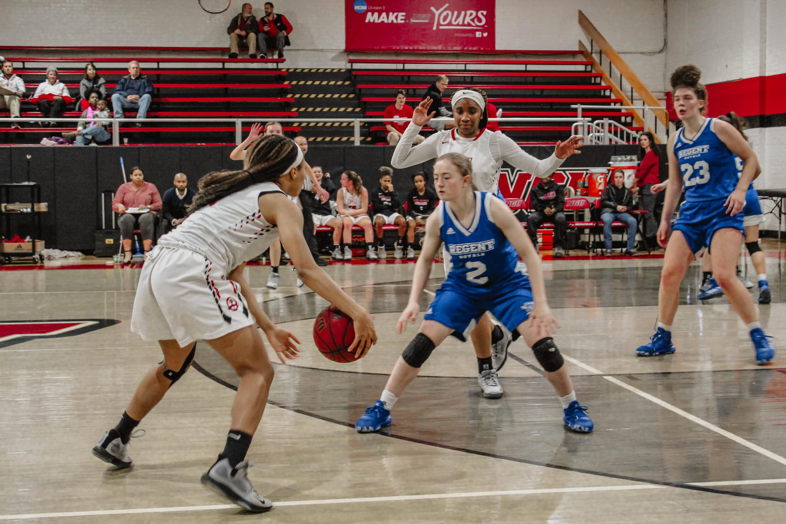 Senior Damiya Montgomery (11) is defended as she brings the ball down the court, while Chelsea Martin (24) runs toward the defender preparing to set a pick.