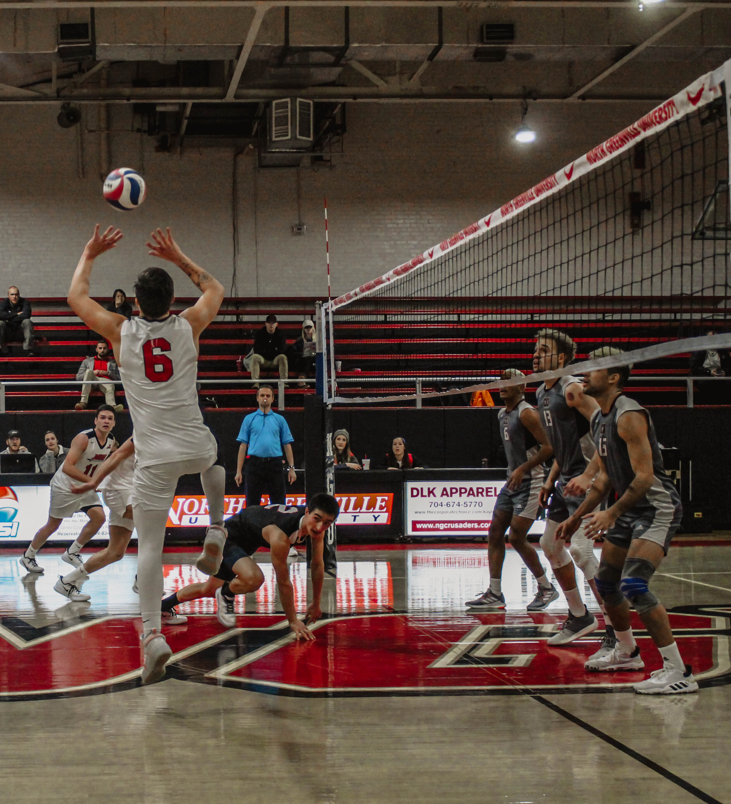 Jake Boldog (6) sets the ball to his teammate as three Campbellsville players wait for the spike.