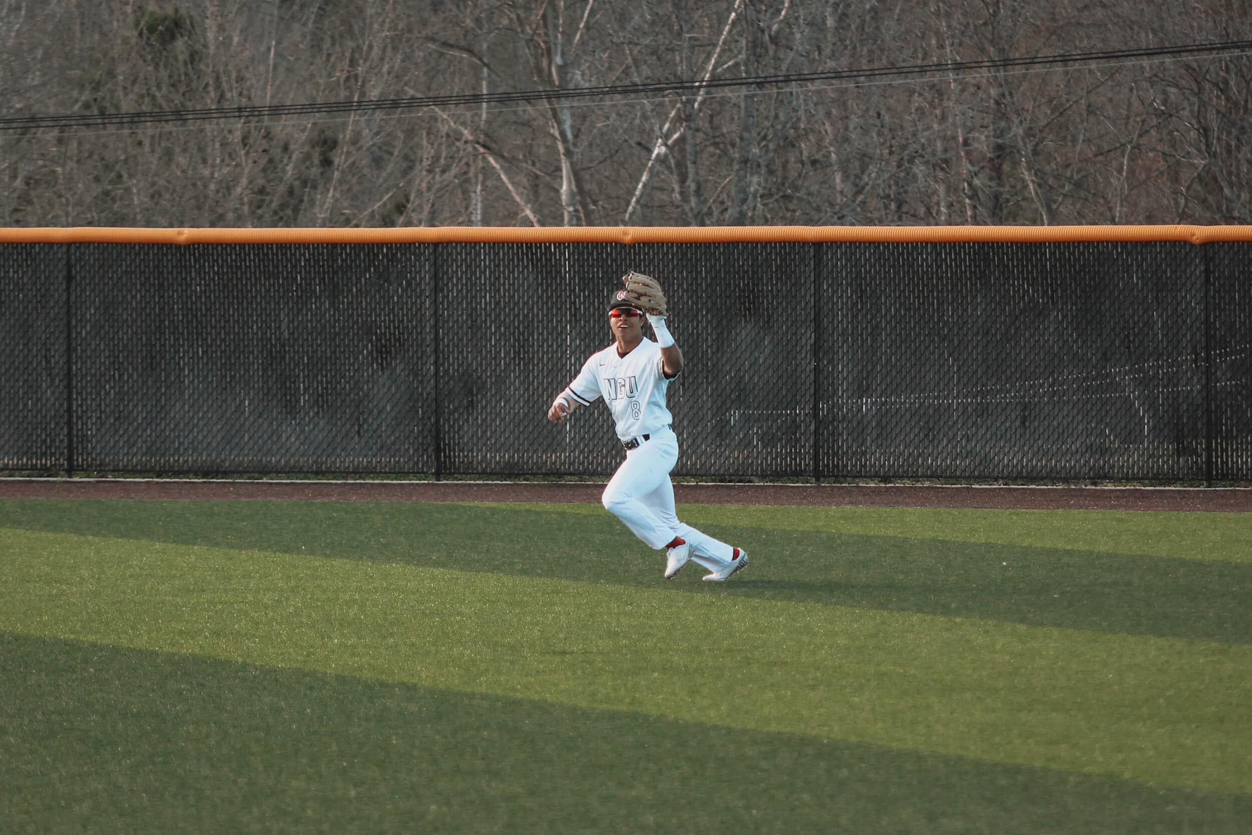 Outfielder, Jeremy Whitehead (8) makes a catch in the outfield getting a Panther player out.