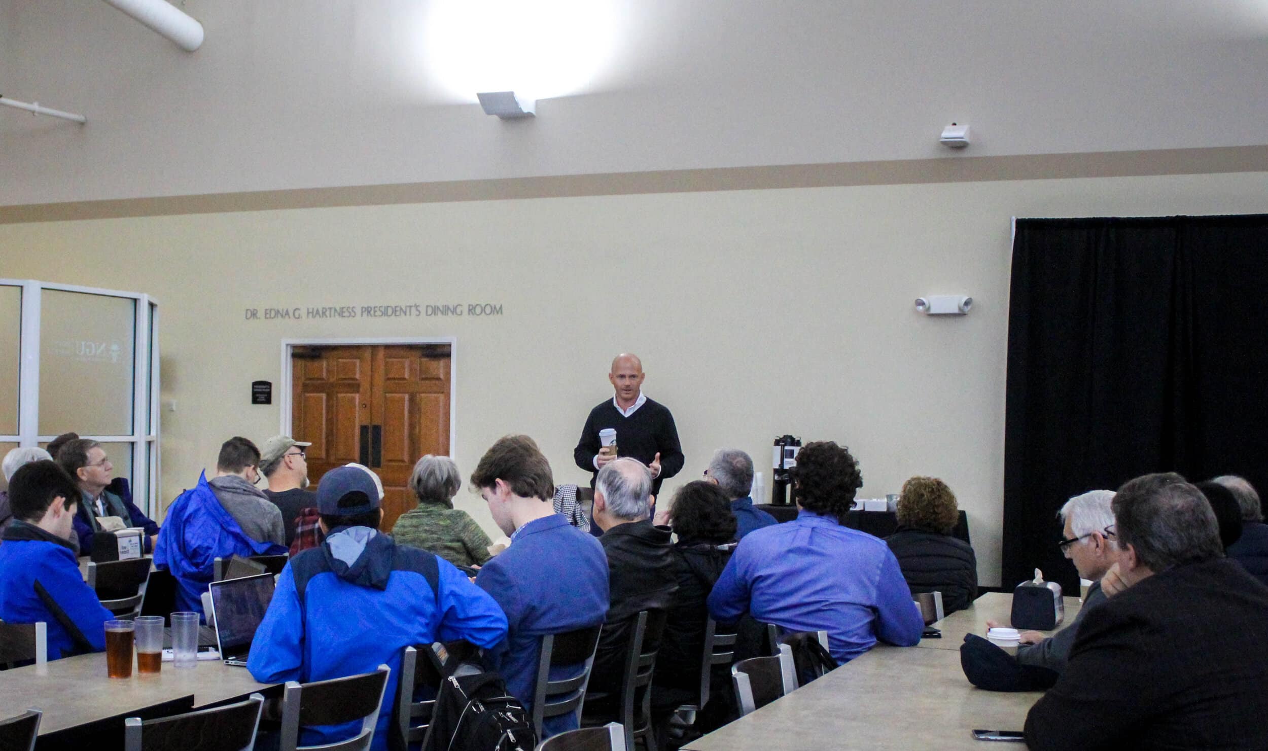 A large crowd from the community attends the meeting.