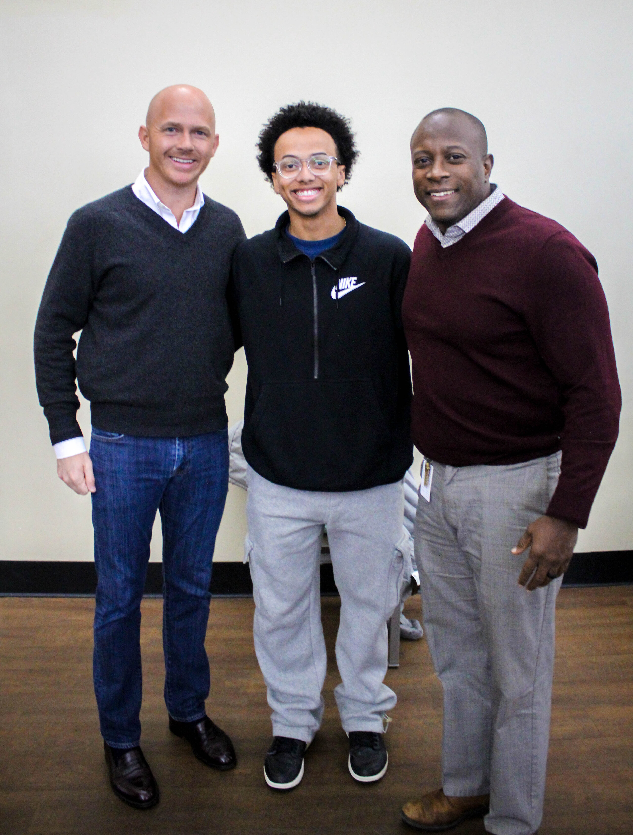 Isaac Landon, a North Greenville University student, and Lamont Sullivan, NGUs director of alumni engagement, talk with Timmons and take a photo after the meeting.