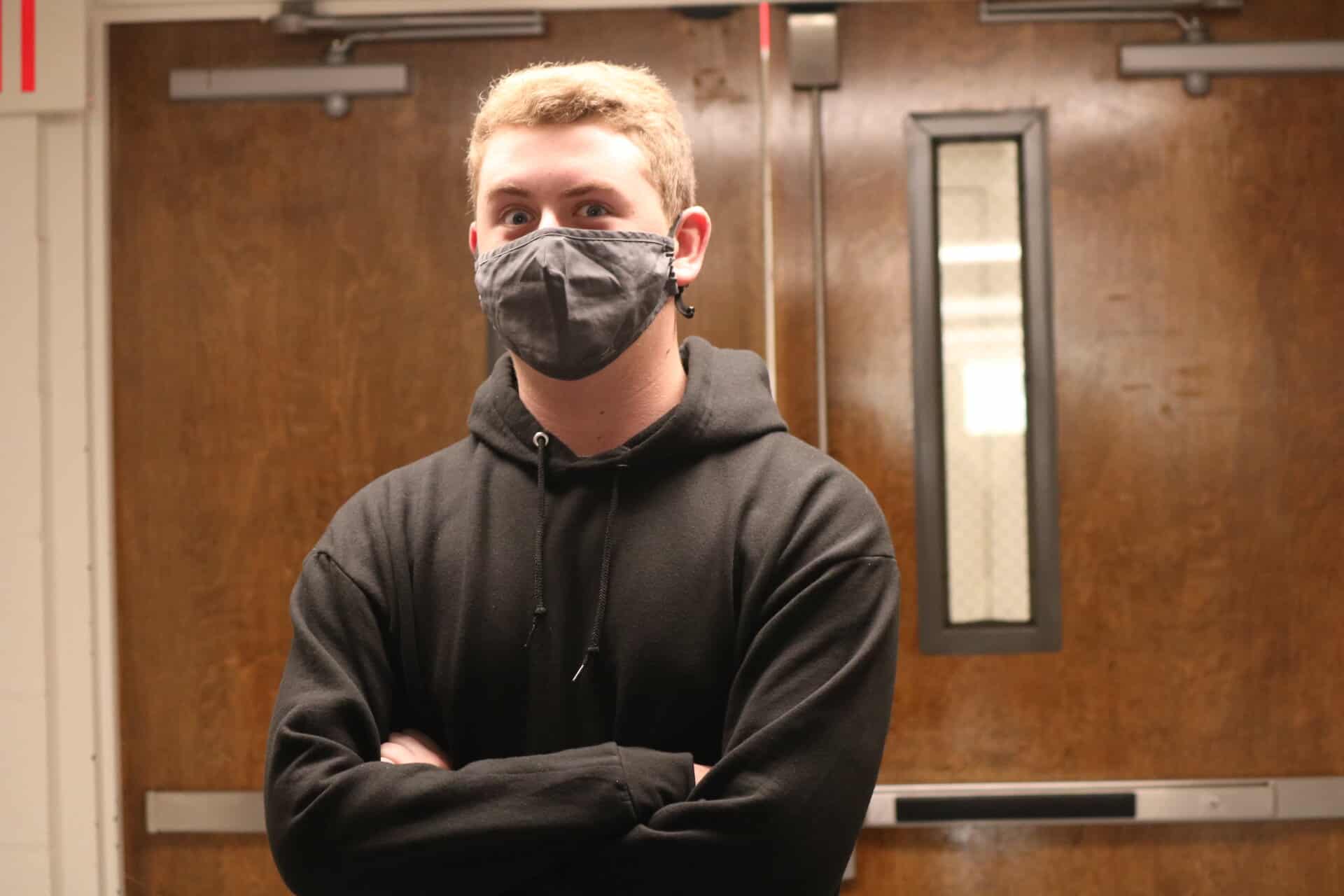 Garrick Hagen, freshman business administration major shares a silly face and sports a black hoodie after working an event for the media team.