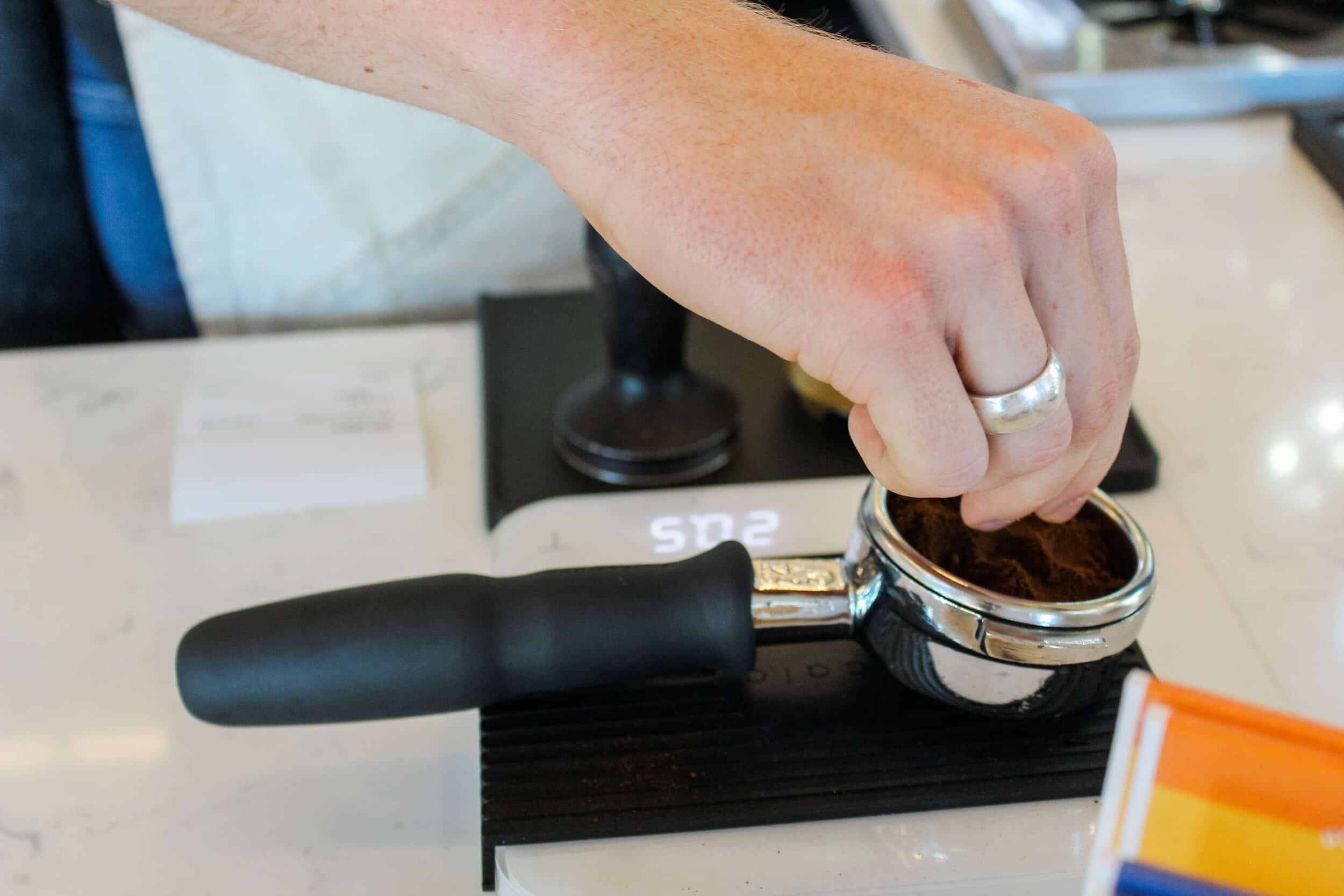 The barista needs to weigh the espresso to get precise measurements of ingredients.