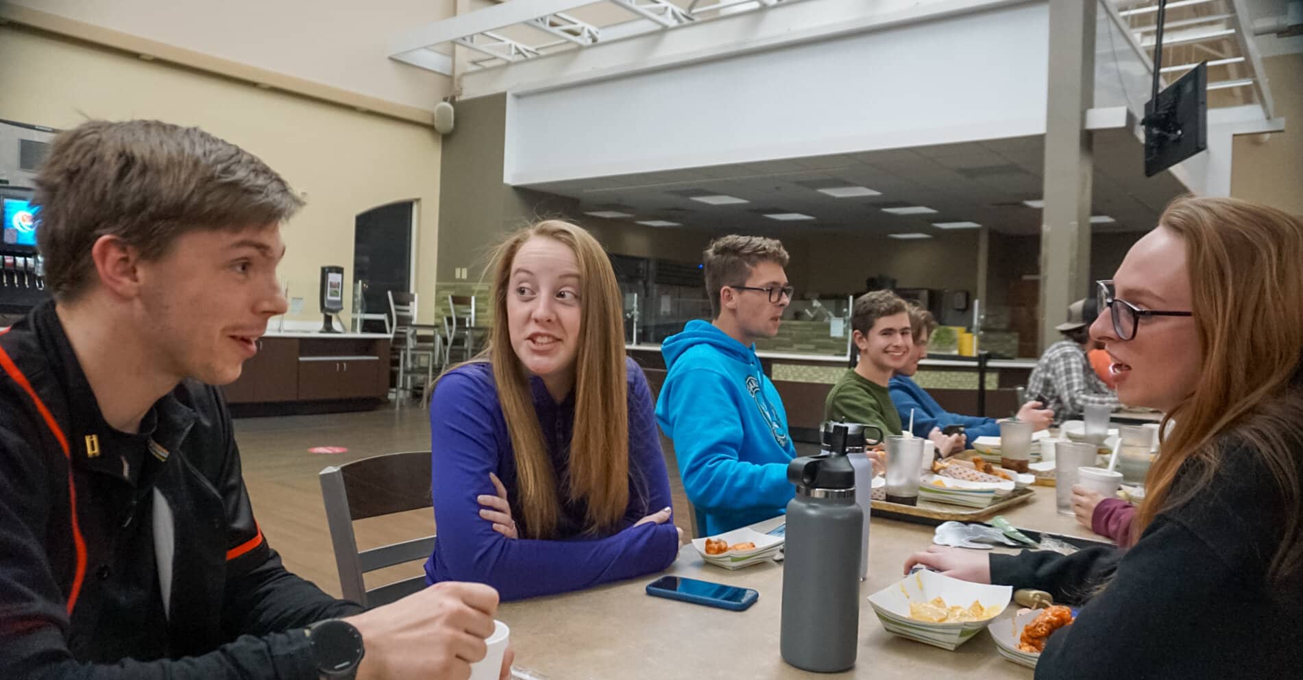 Freshman students Logan Johnson, Katie Bingham and Katherine Palm take a break from watching the game to talk about this weeks wintery weather surprise.