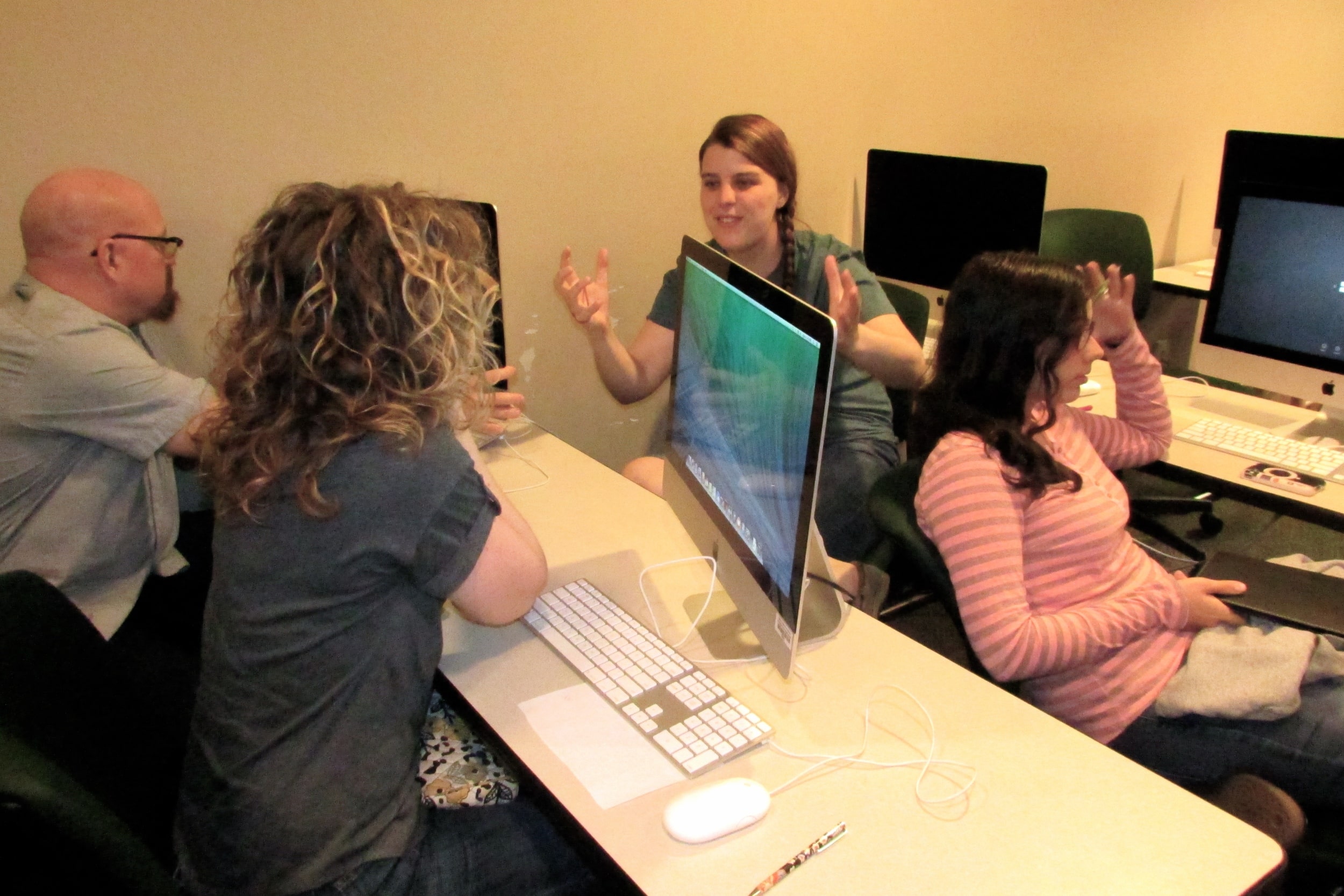 Students who write for "The Vision Online" discuss upcoming stories during a weekly meeting.