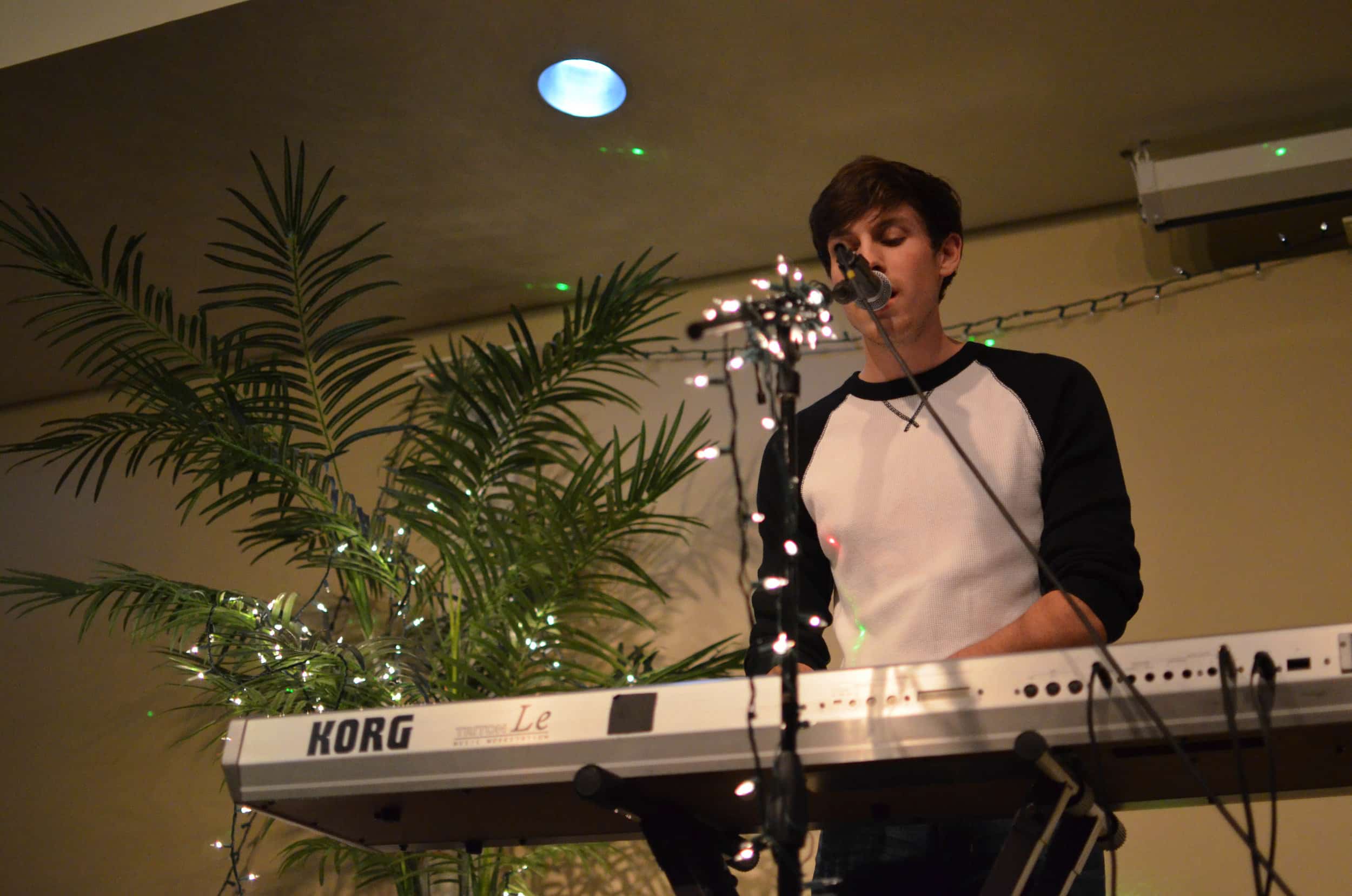 Quinn Varnado sings and plays the keyboard at coffeehouse.