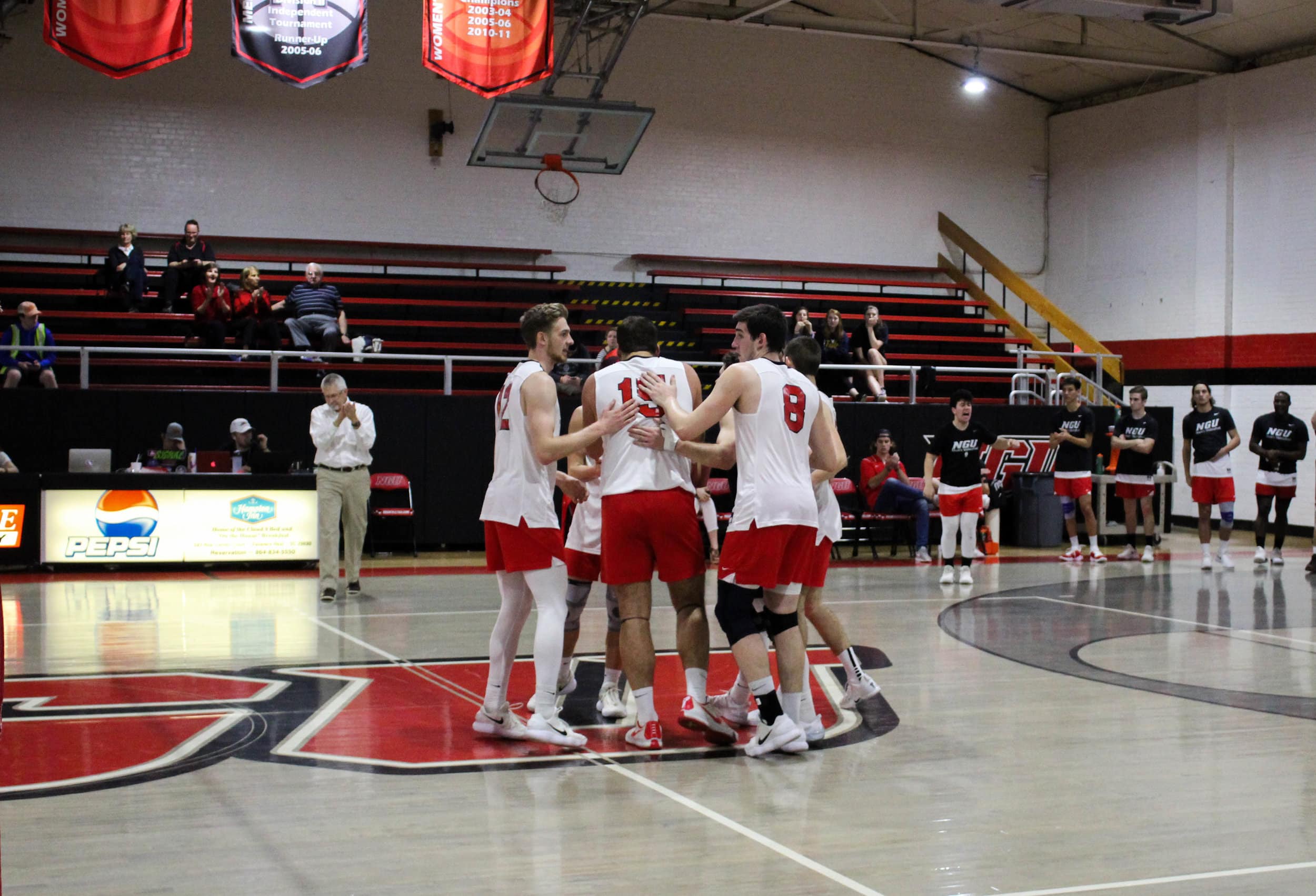The NGU Mens Volleyball team congratulate Matthew McManaway (15) after he spiked the ball over the net scoring the Crusaders a point.