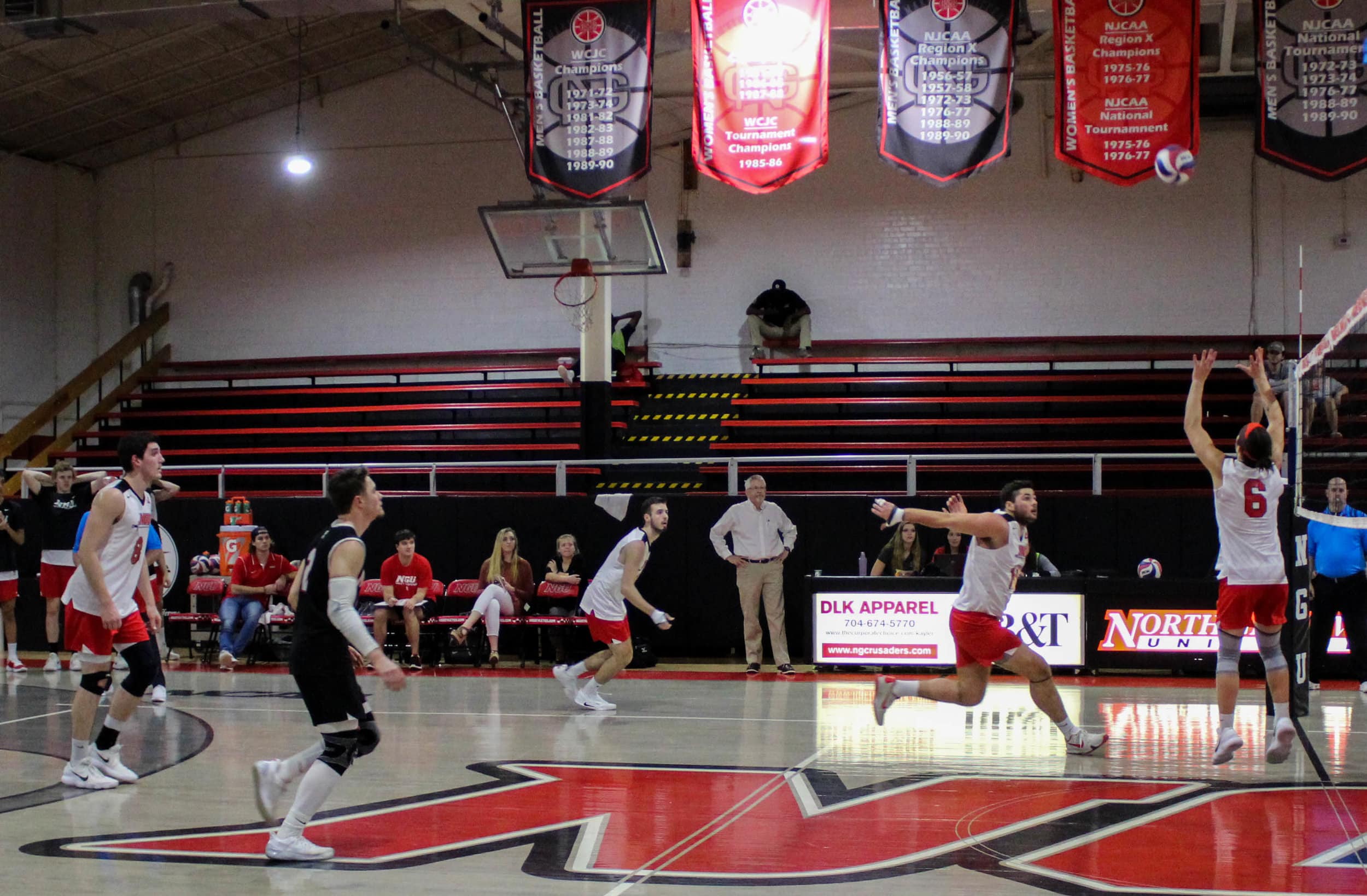 Matthew McManaway (15) prepares to spike the ball as he runs towards the net while Jake Boldog (6) sets the ball to him.