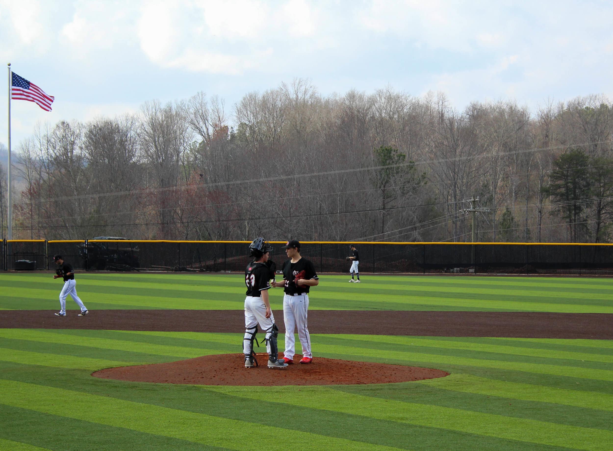 Lex Tuten (23) and Ethan Garner (27) talk on the mound about pitch strategy.