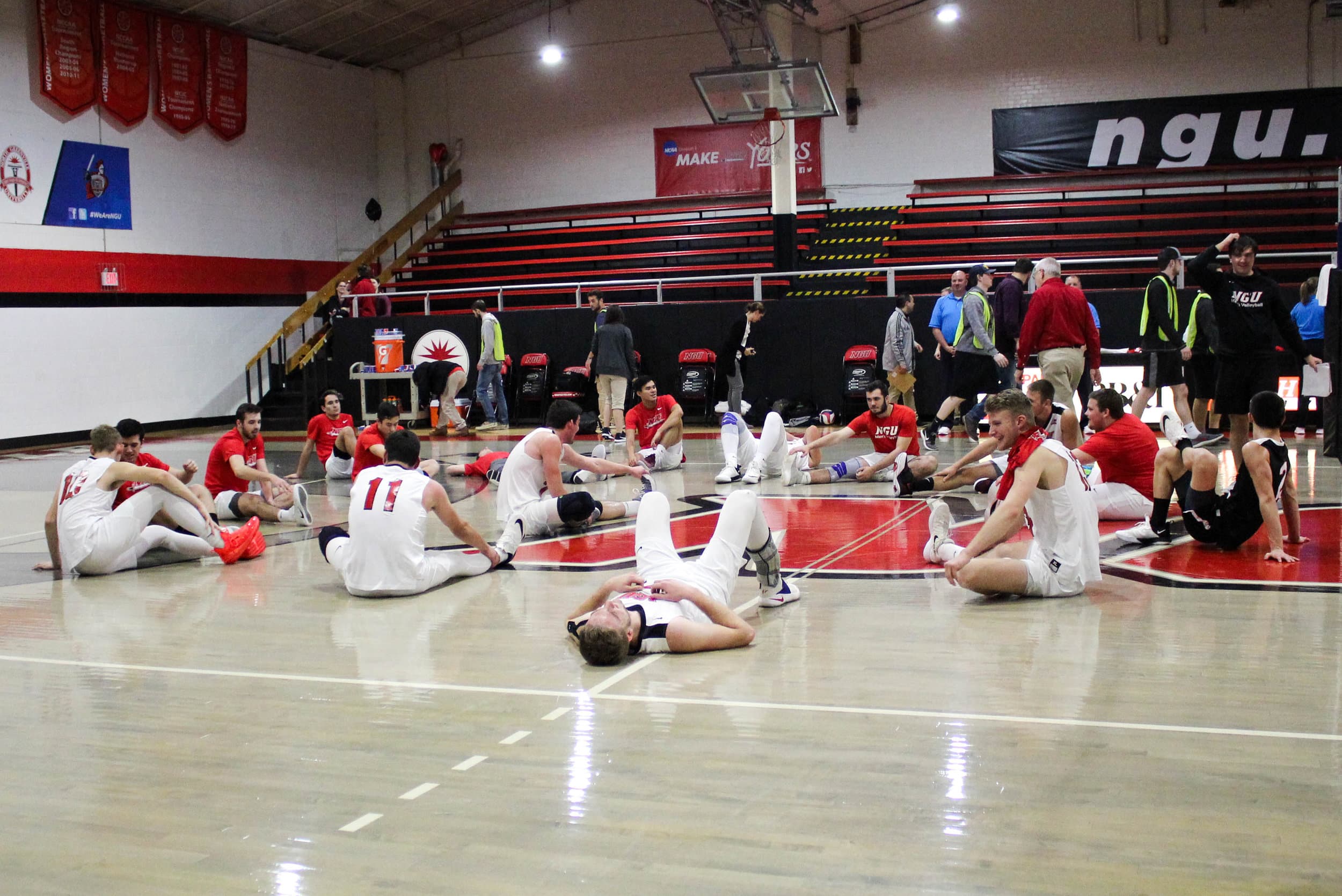 After all five sets, the team sits on the ground to stretch.