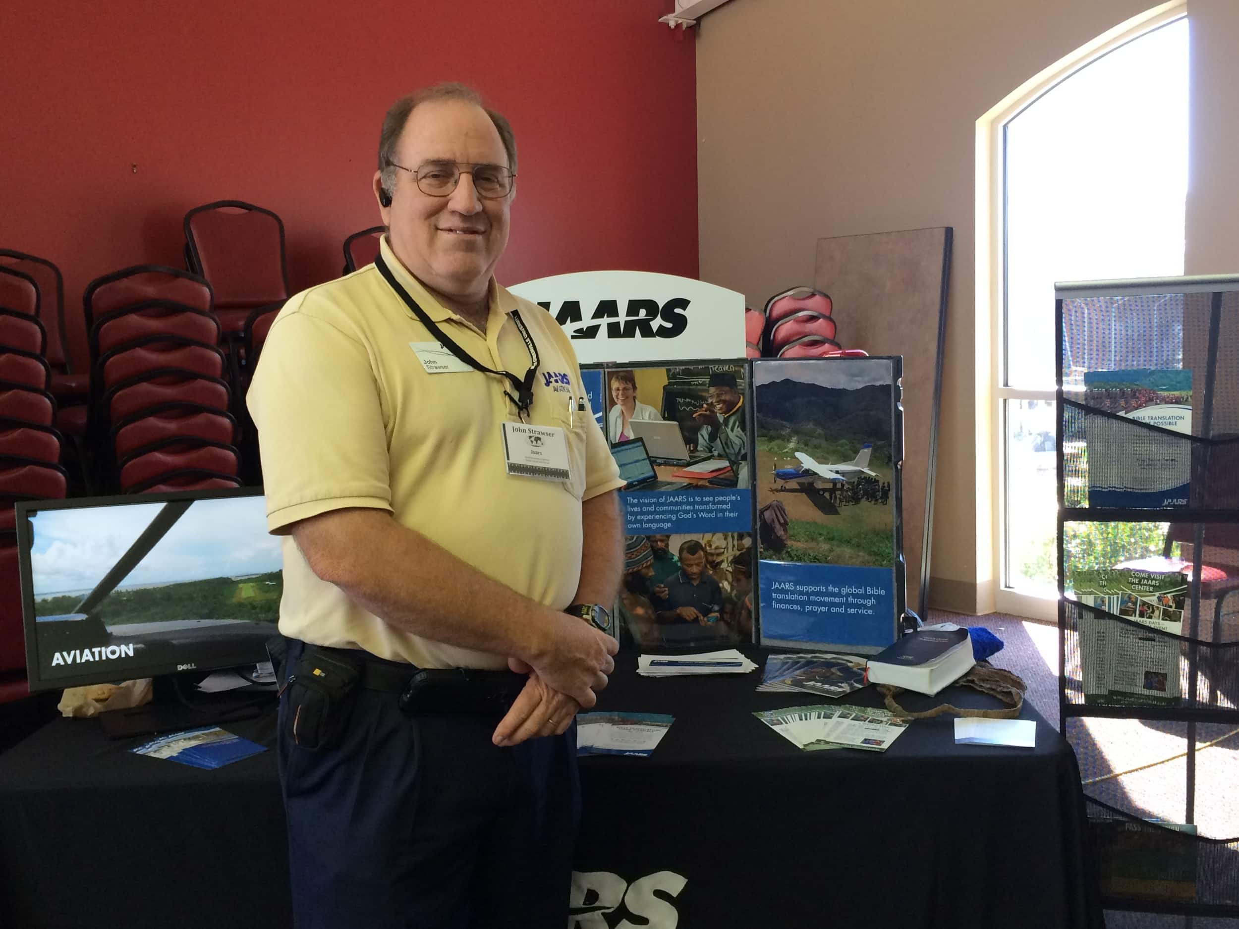 John Strawers takes time for a picture in front of his JAARS booth.