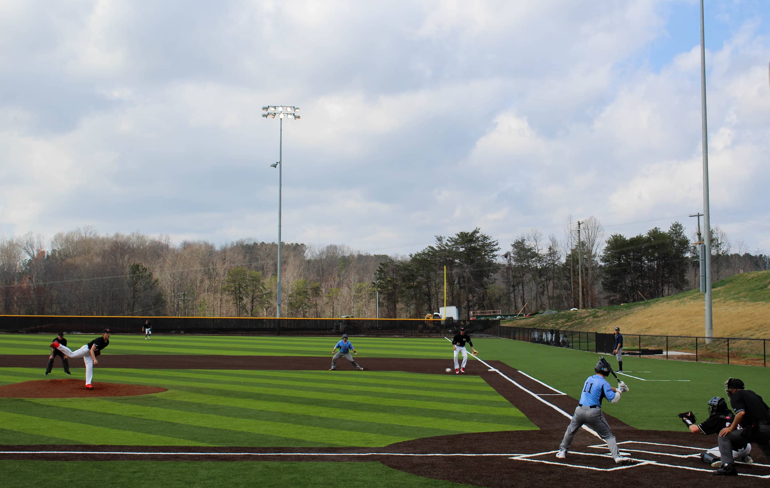 Ethan Garner (27) pitches the baseball while a right handed batter from NU is up to bat.