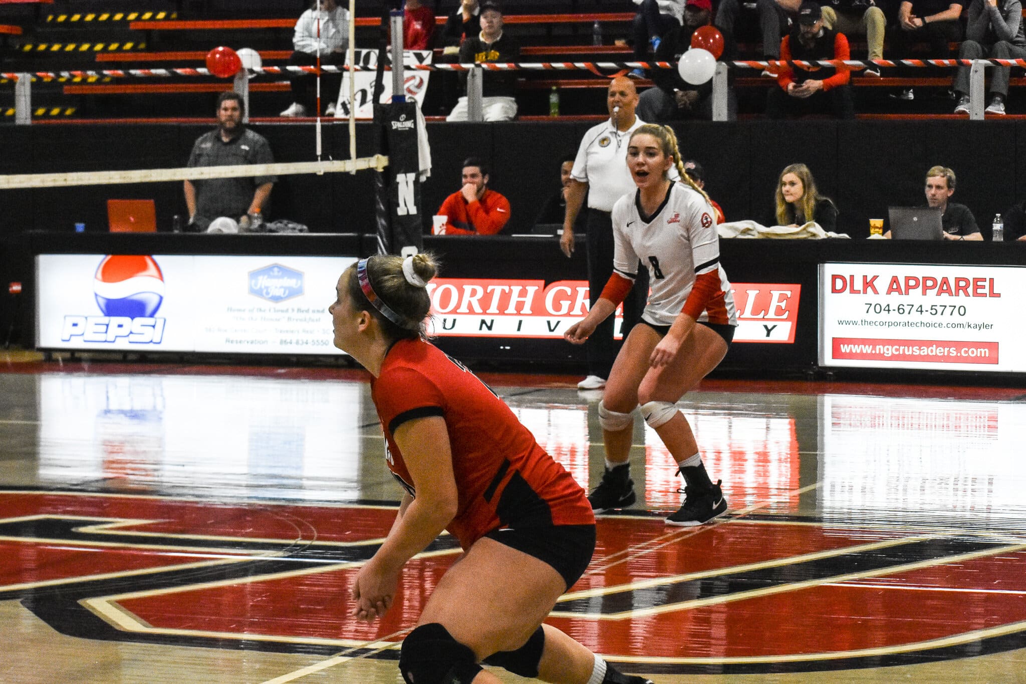 Sophomore Whitley Kahler (20) hits the ball over the net.