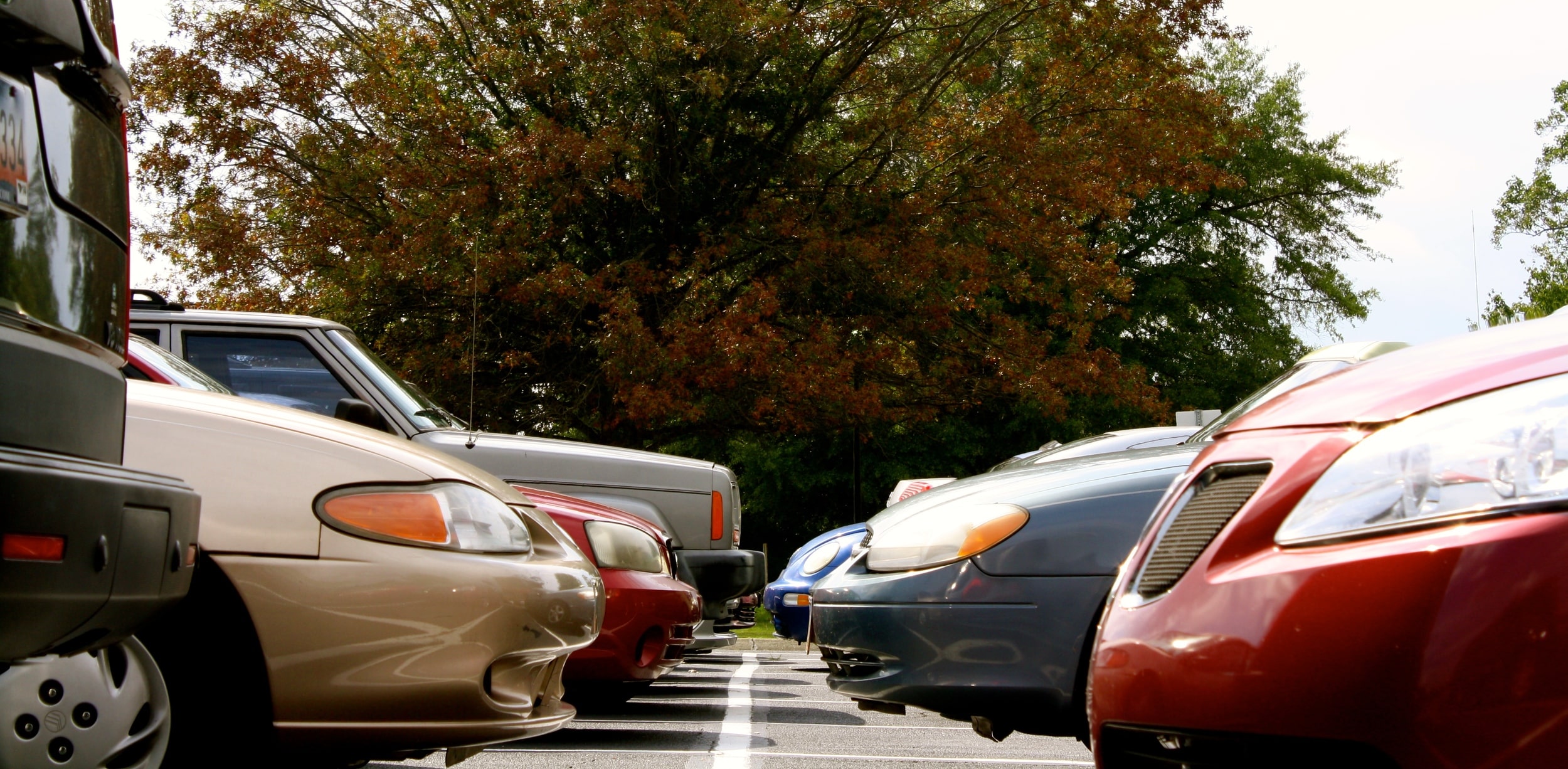 Student cars pile into the campus parking lot.