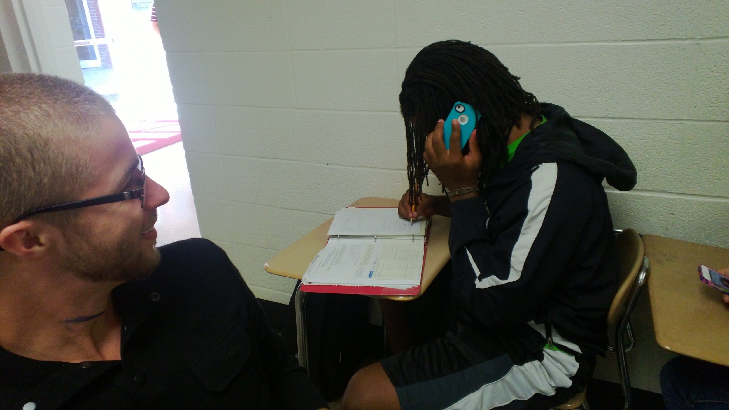 Freshman&nbsp;Eddie Studyvance (right) takes a phone call during class.