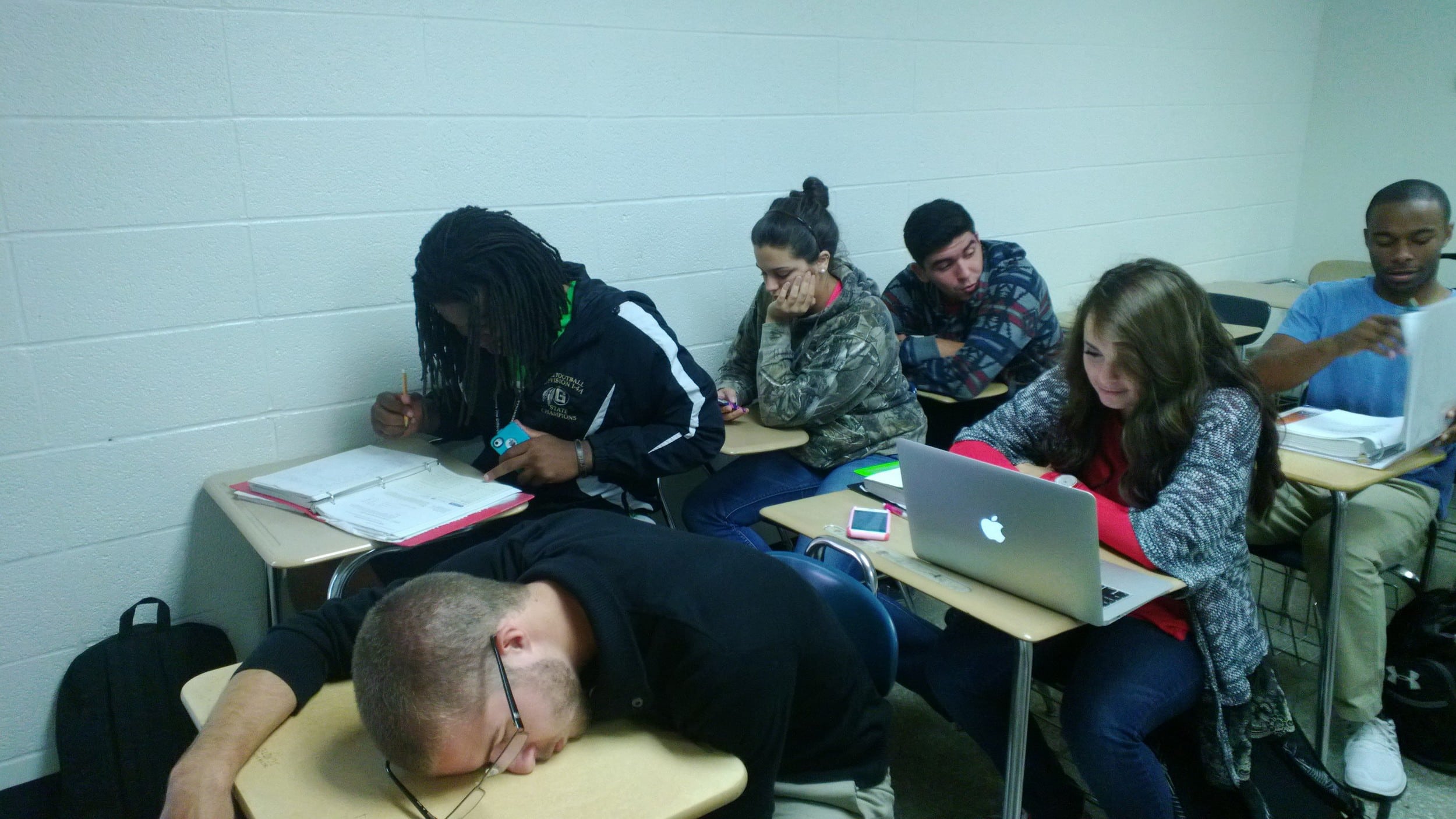 Freshman William McDonald (bottom left) sleeps during class.