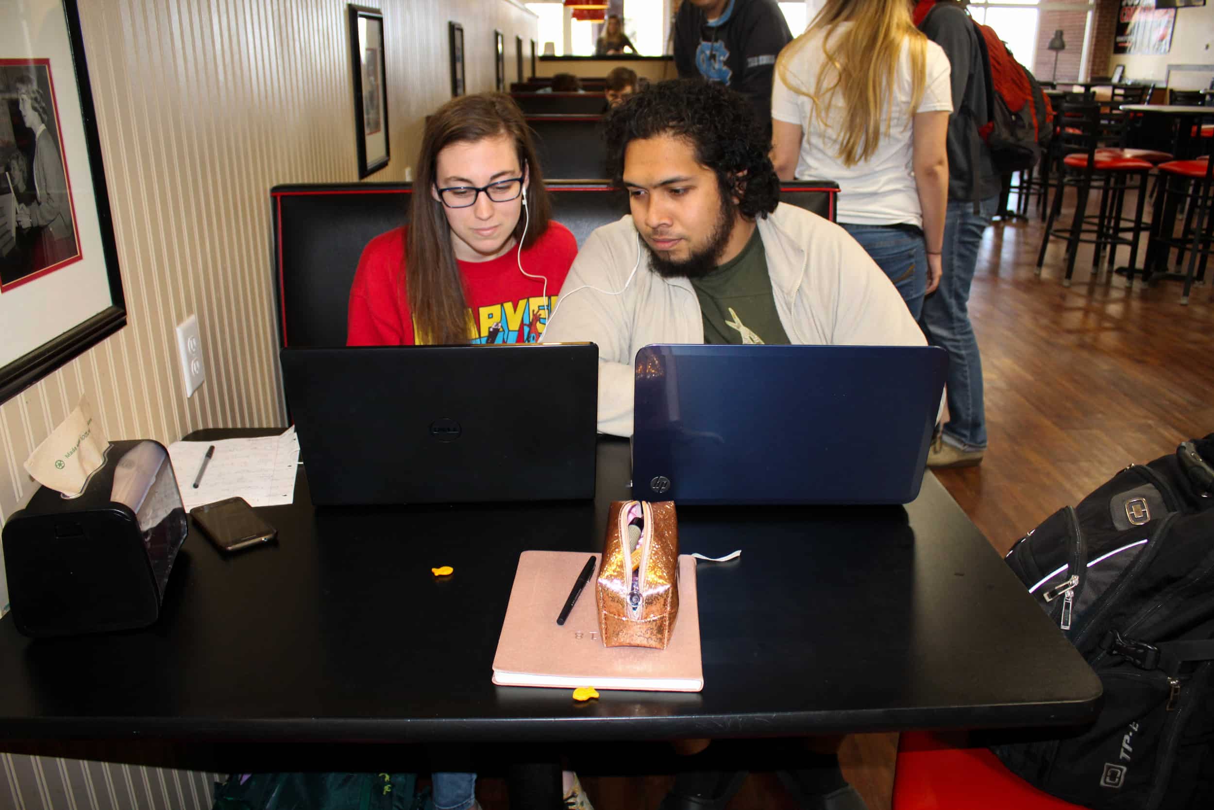 Biology majors Rachel Buko and David Balles sit in the stud and watch a video together.