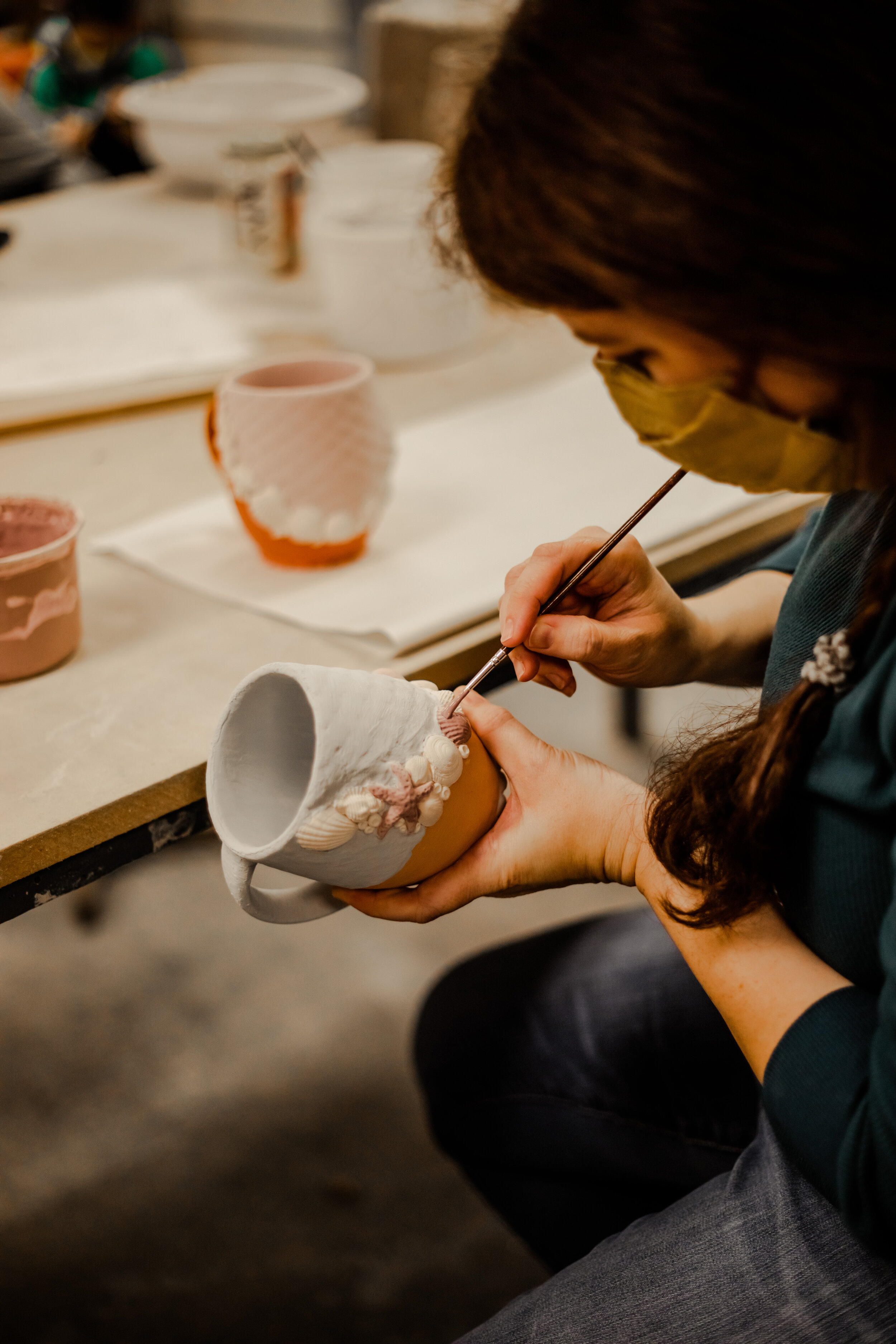 She specializes in creating ocean-themed coffee mugs.