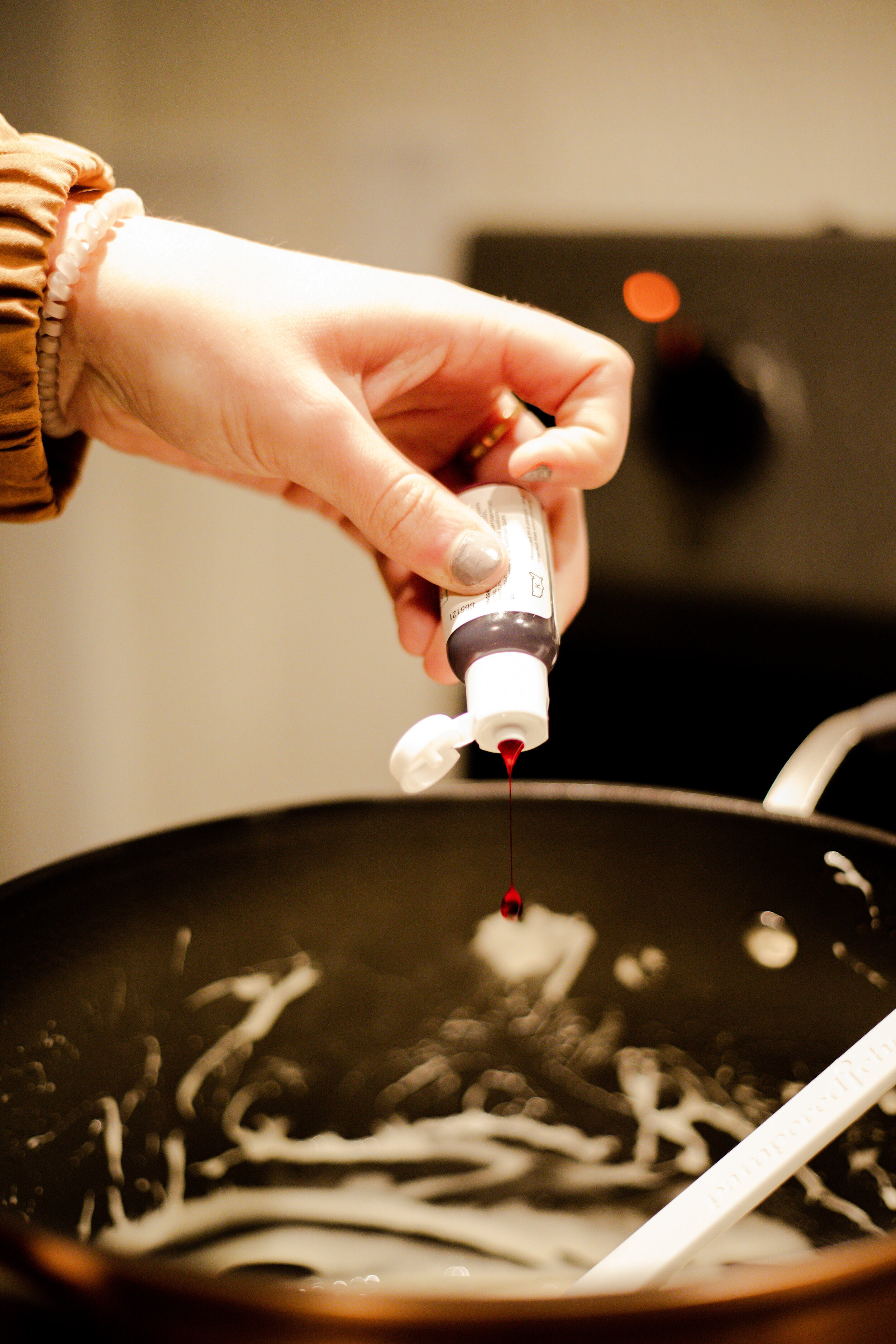 Once they have fully melted, stir a few drops of orange food coloring into the marshmallows until you get the desired color; 3 or 4 drops should do the trick.