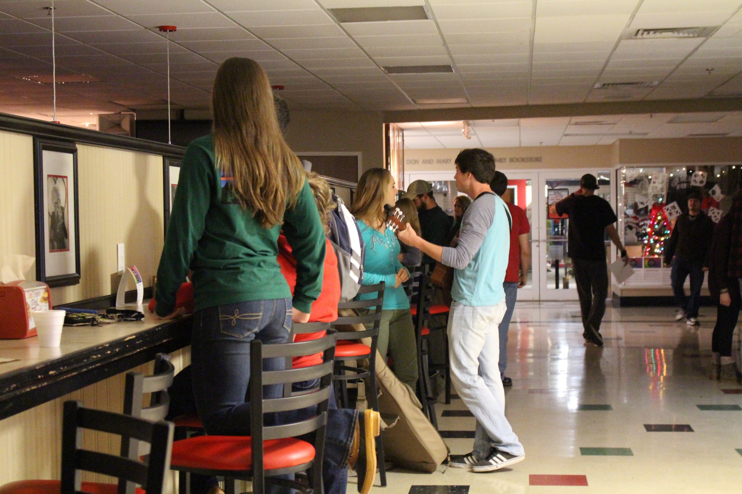 Students preparing to perform and rehearsing for the coffeehouse