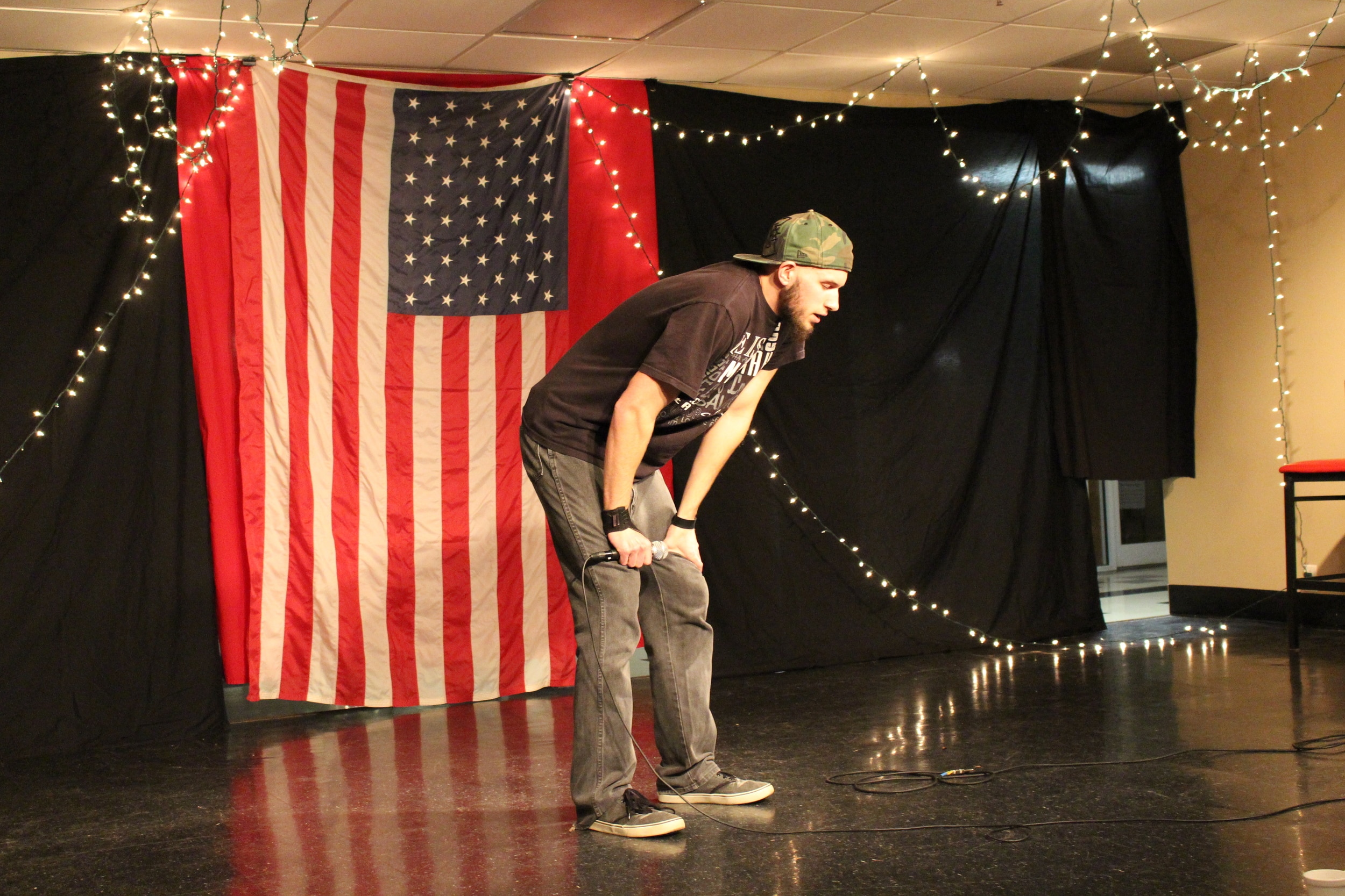 Gabe Herndon saying a prayer before performing a powerful spoken word.