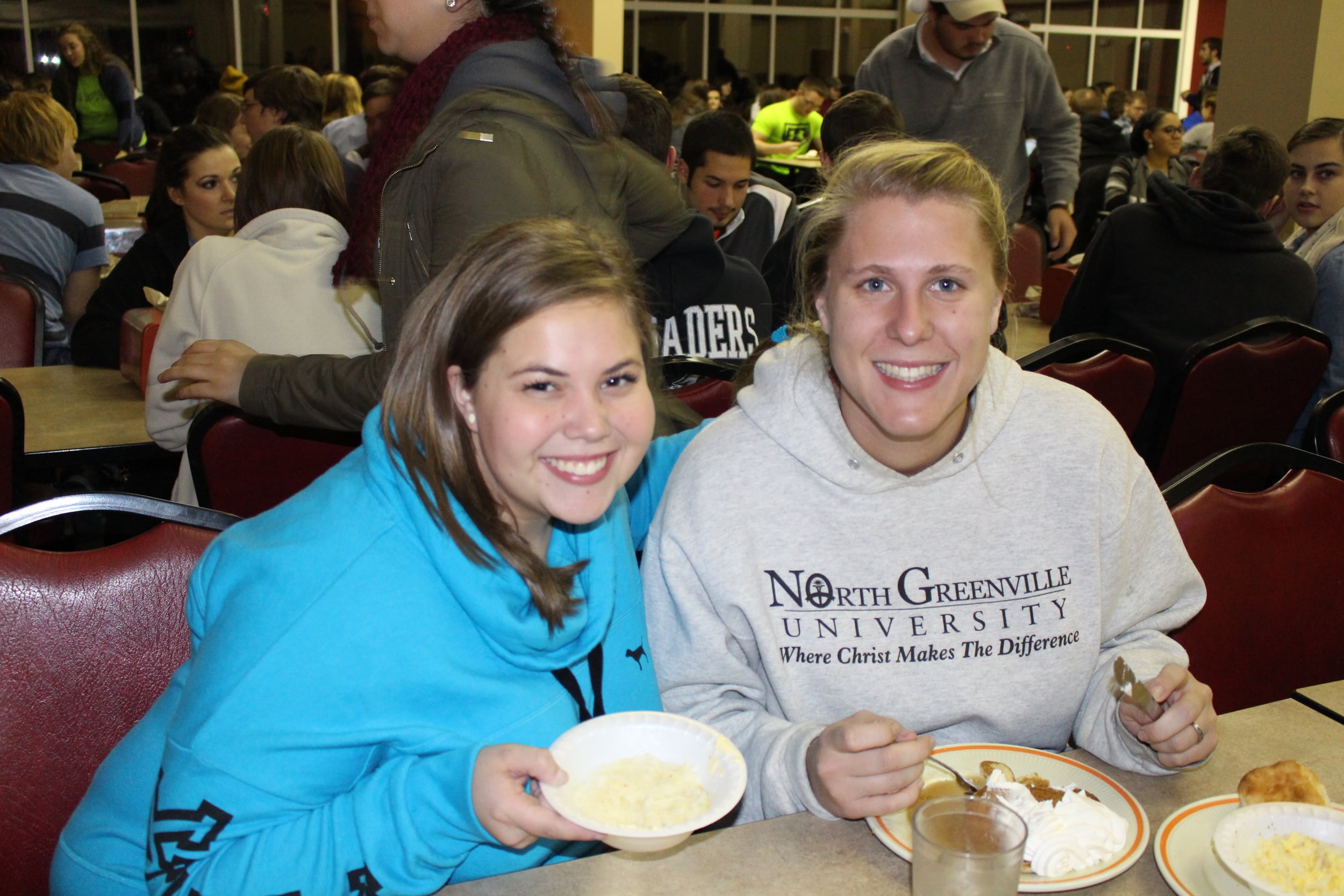 Abby Batson and Ashley Silvey enjoy the grits and pancakes before exams begin.