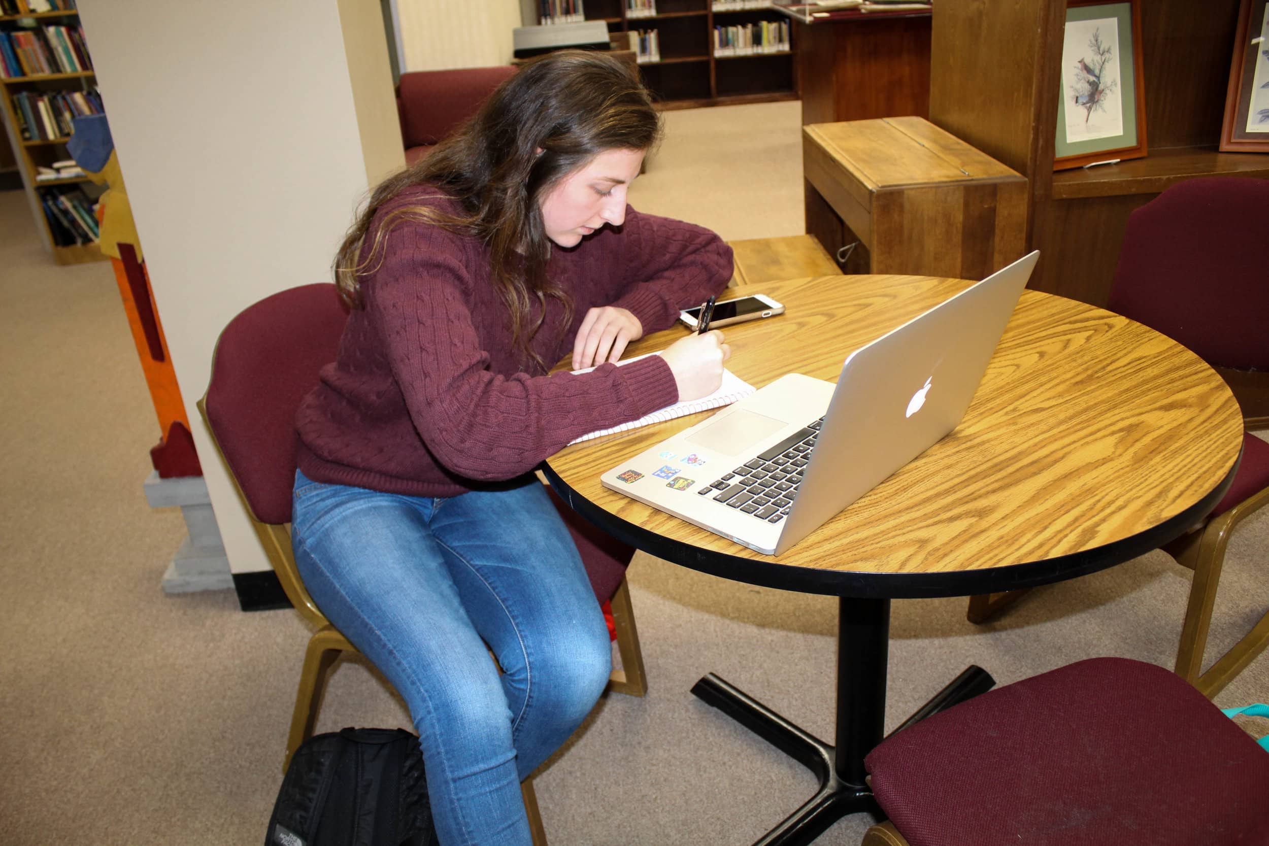 Kyli Schmitt, a junior biology major, uses her laptop as she studies in the library.